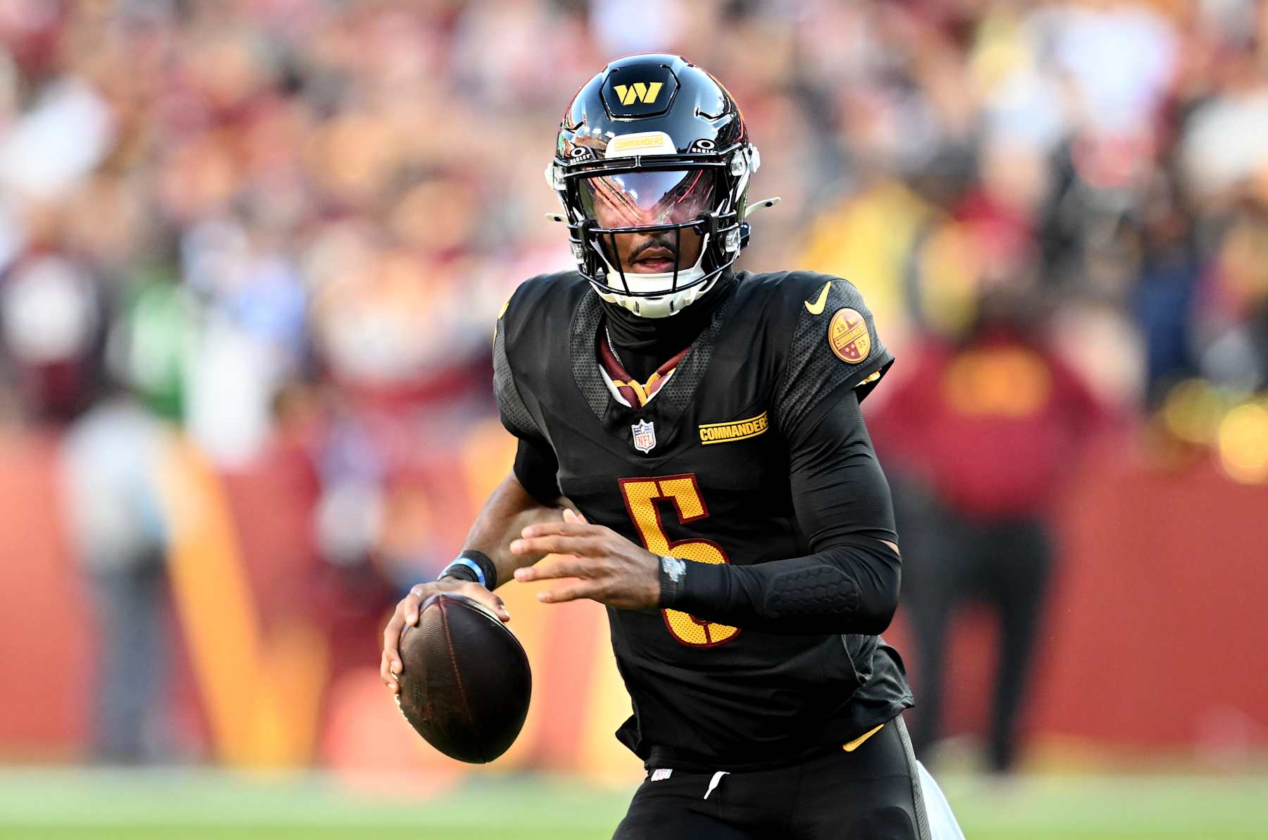 LANDOVER, MARYLAND - OCTOBER 27: Jayden Daniels #5 of the Washington Commanders drops back to pass against the Chicago Bears at Northwest Stadium on October 27, 2024 in Landover, Maryland. (Photo by G Fiume/Getty Images)