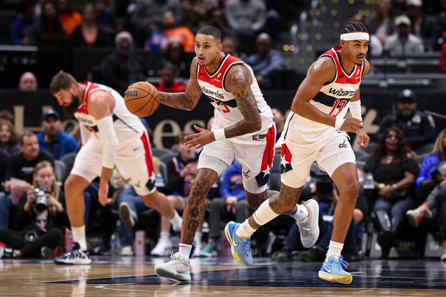 WASHINGTON, DC - OCTOBER 18: Kyle Kuzma #33 of the Washington Wizards brings the ball up court alongside Jonas Valanciunas #17 and Jordan Poole #13 during the first half of the preseason game against the New York Knicks at Capital One Arena on October 18, 2024 in Washington, DC. NOTE TO USER: User expressly acknowledges and agrees that, by downloading and or using this photograph, User is consenting to the terms and conditions of the Getty Images License Agreement. (Photo by Scott Taetsch/Getty Images)