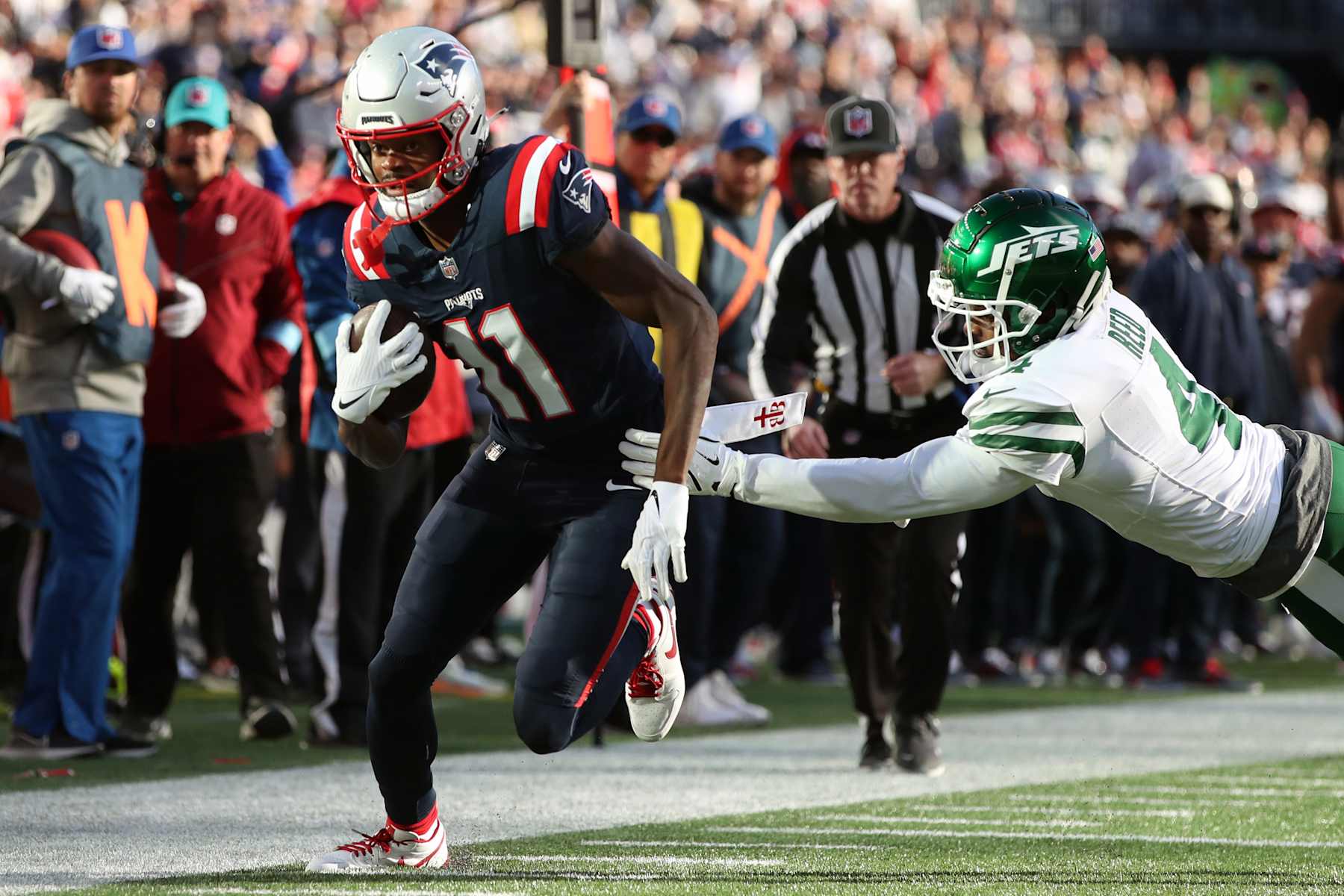 FOXBOROUGH, MASSACHUSETTS - OCTOBER 27: Tyquan Thornton #11 of the New England Patriots runs with the ball against D.J. Reed #4 of the New York Jets during the fourth quarter at Gillette Stadium on October 27, 2024 in Foxborough, Massachusetts. (Photo by Adam Glanzman/Getty Images)