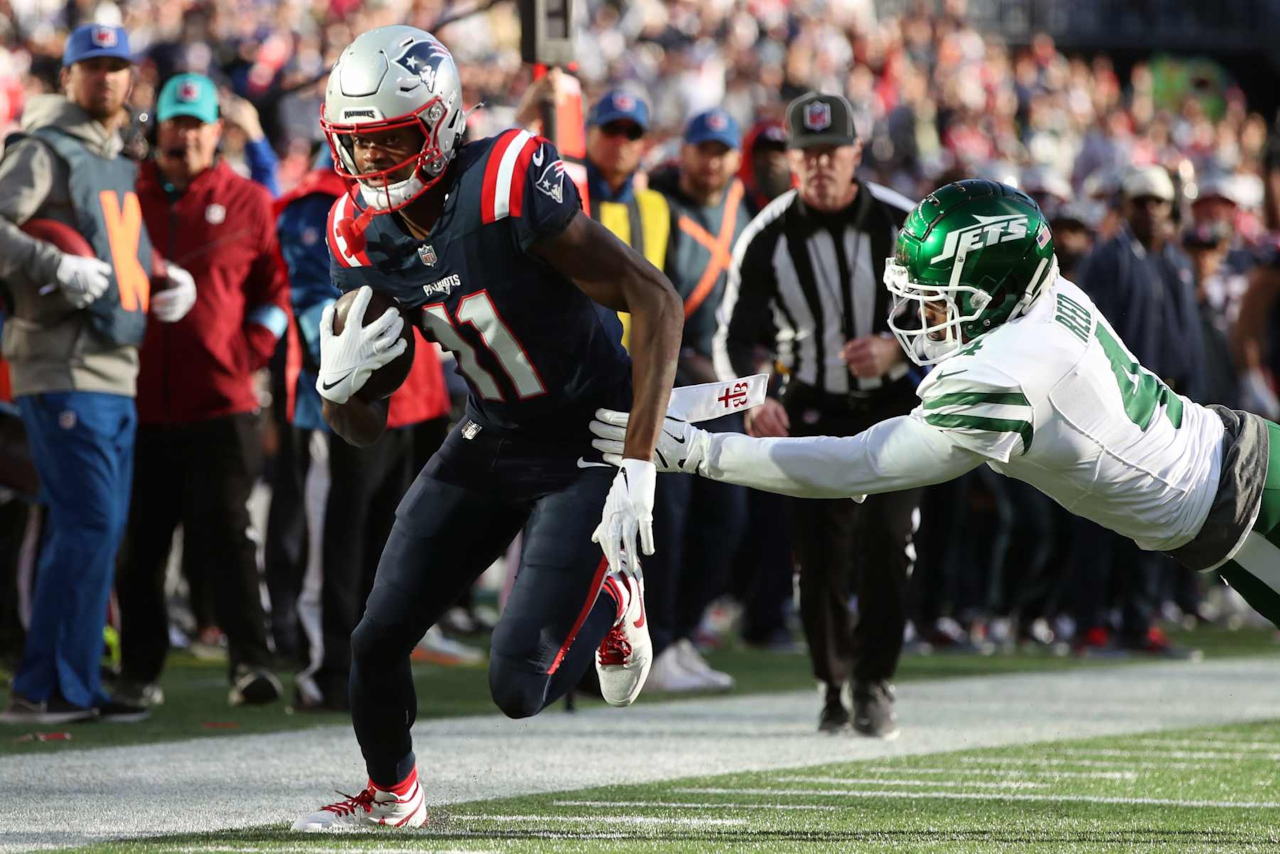 FOXBOROUGH, MASSACHUSETTS - OCTOBER 27: Tyquan Thornton #11 of the New England Patriots runs with the ball against D.J. Reed #4 of the New York Jets during the fourth quarter at Gillette Stadium on October 27, 2024 in Foxborough, Massachusetts. (Photo by Adam Glanzman/Getty Images)
