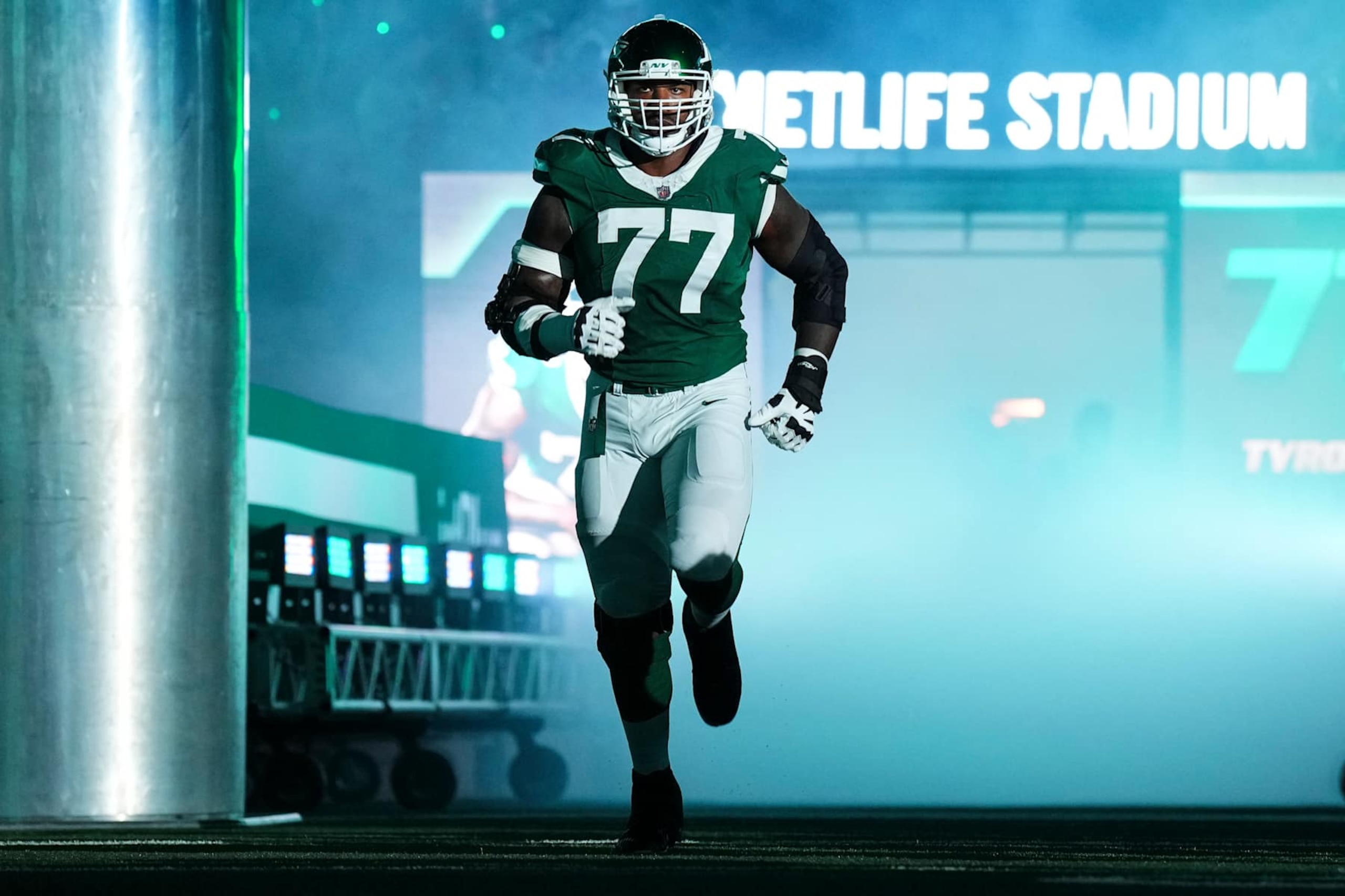 EAST RUTHERFORD, NJ - SEPTEMBER 19: Tyron Smith #77 of the New York Jets runs out of the tunnel prior to an NFL football game against the New England Patriots at MetLife Stadium on September 19, 2024 in East Rutherford, New Jersey. (Photo by Cooper Neill/Getty Images)