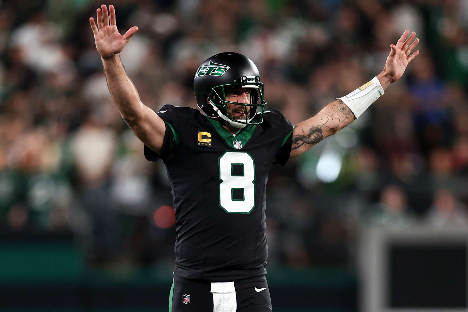 EAST RUTHERFORD, NEW JERSEY - OCTOBER 31: Aaron Rodgers #8 of the New York Jets celebrates after scoring a touchdown during the second half of an NFL football game against the Houston Texans, at MetLife Stadium on October 31, 2024 in East Rutherford, New Jersey. (Photo by Kevin Sabitus/Getty Images)