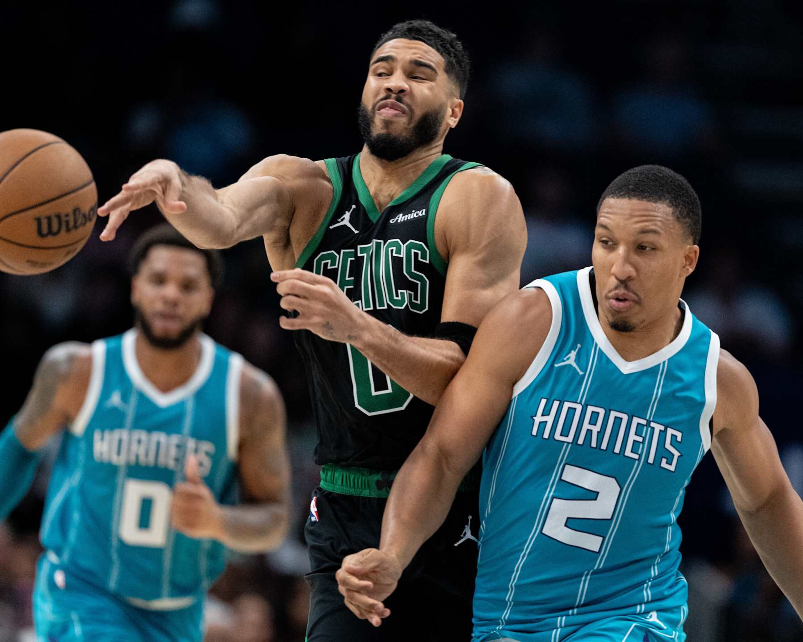 CHARLOTTE, NORTH CAROLINA - NOVEMBER 01: Grant Williams #2 of the Charlotte Hornets fouls Jayson Tatum #0 of the Boston Celtics in the fourth quarter during their game at Spectrum Center on November 01, 2024 in Charlotte, North Carolina. NOTE TO USER: User expressly acknowledges and agrees that, by downloading and or using this photograph, User is consenting to the terms and conditions of the Getty Images License Agreement. (Photo by Jacob Kupferman/Getty Images)