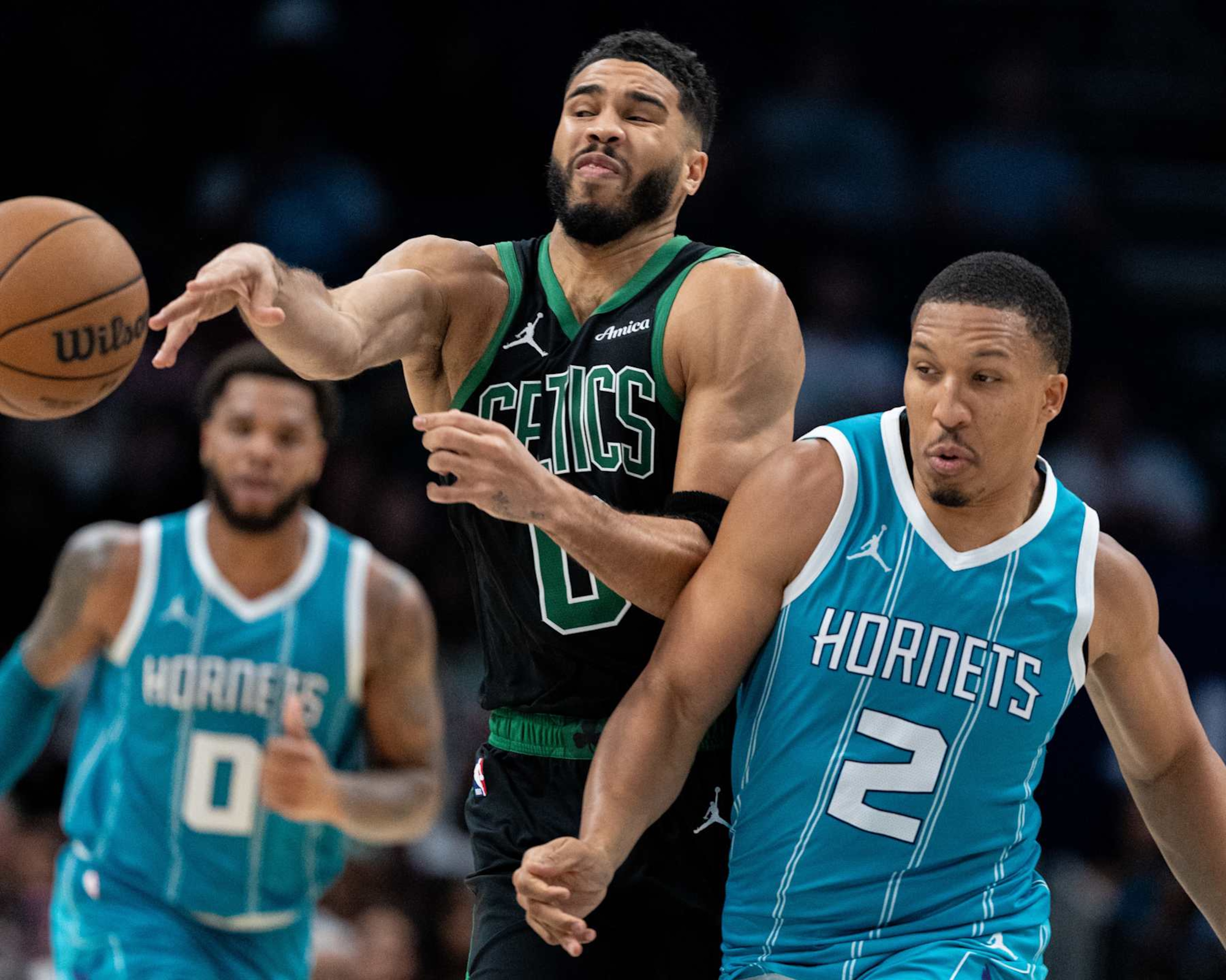 CHARLOTTE, NORTH CAROLINA - NOVEMBER 01: Grant Williams #2 of the Charlotte Hornets fouls Jayson Tatum #0 of the Boston Celtics in the fourth quarter during their game at Spectrum Center on November 01, 2024 in Charlotte, North Carolina. NOTE TO USER: User expressly acknowledges and agrees that, by downloading and or using this photograph, User is consenting to the terms and conditions of the Getty Images License Agreement. (Photo by Jacob Kupferman/Getty Images)