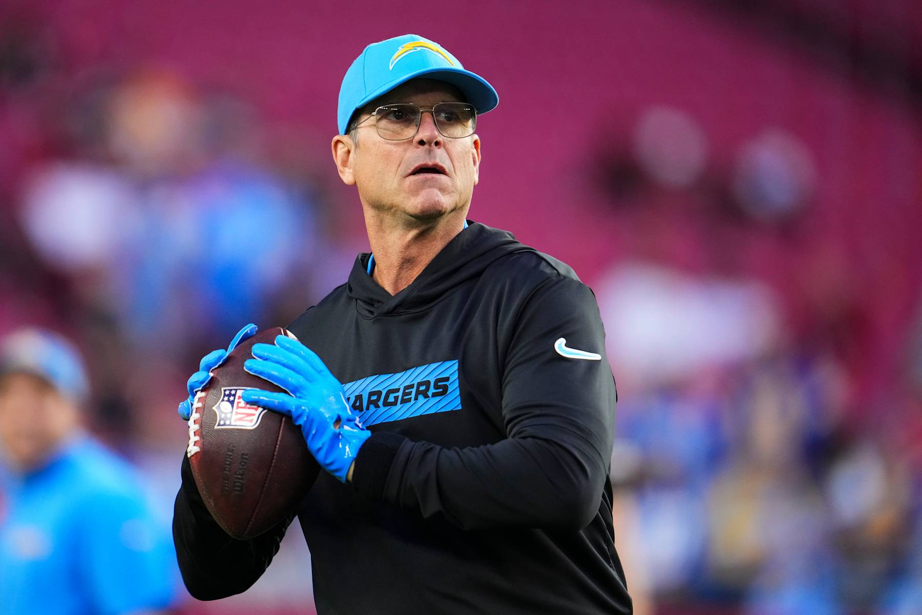 GLENDALE, AZ - OCTOBER 21: Los Angeles Chargers head coach Jim Harbaugh warms up prior to an NFL football game against the Arizona Cardinals at State Farm Stadium on October 21, 2024 in Glendale, Arizona. (Photo by Cooper Neill/Getty Images)