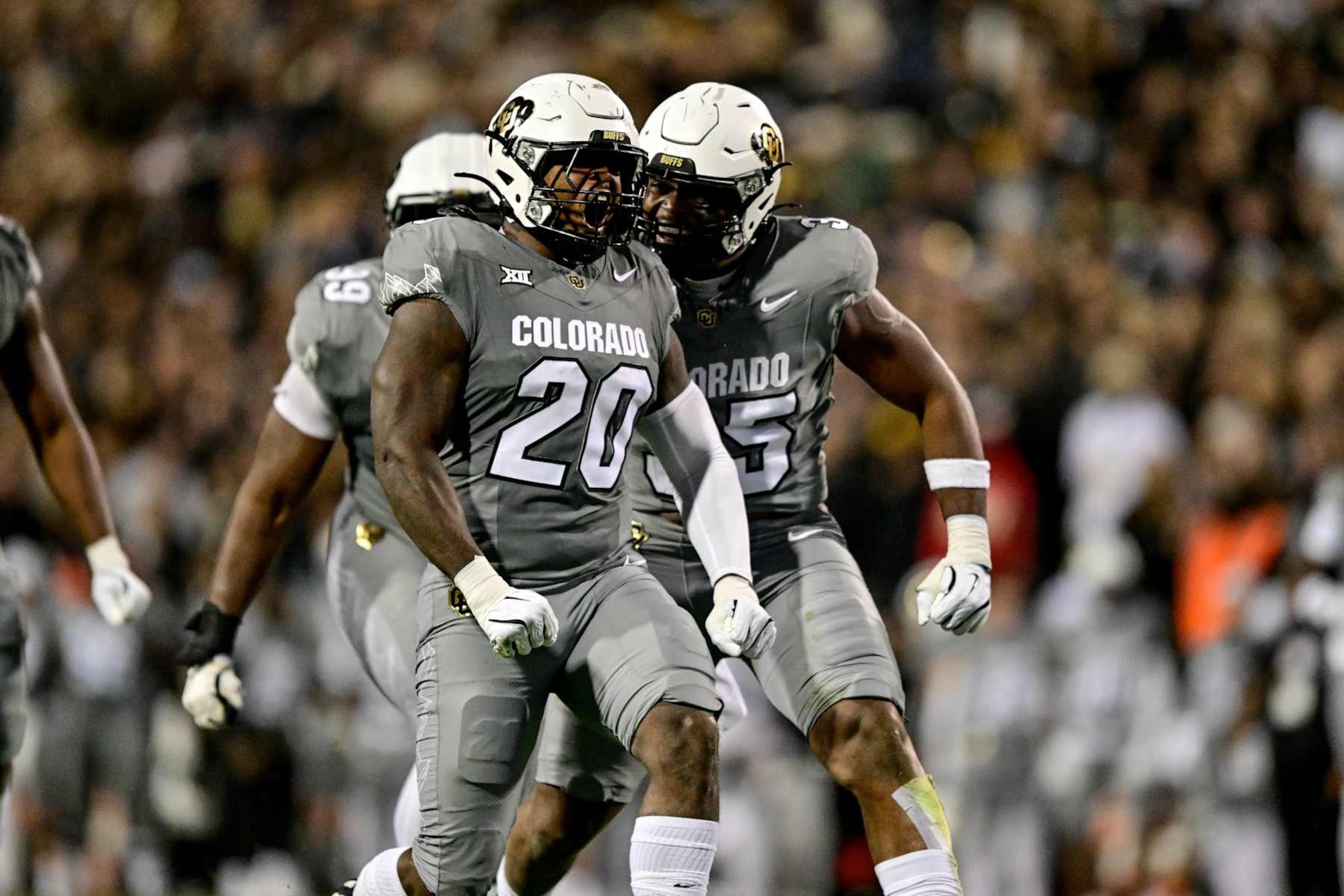 BOULDER, CO - OCTOBER 26:  LaVonta Bentley #20 of the Colorado Buffaloes celebrates wirth BJ Green II #35 after a defensive play in the first quarter against the Cincinnati Bearcats at Folsom Field on October 26, 2024 in Boulder, Colorado. (Photo by Dustin Bradford/Getty Images)