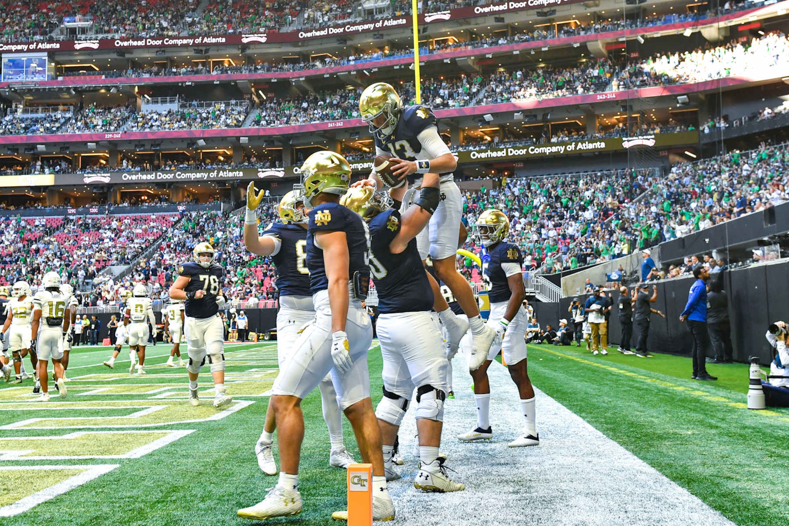 ATLANTA, GA  OCTOBER 19:  Notre Dame offensive lineman Rocco Spindler lifts up quarterback Riley Leonard (13) after he scored a touchdown during the college football game between the Notre Dame Fighting Irish and the Georgia Tech Yellow Jackets on October 19th, 2024 at Mercedes-Benz Stadium in Atlanta, GA.  (Photo by Rich von Biberstein/Icon Sportswire via Getty Images)