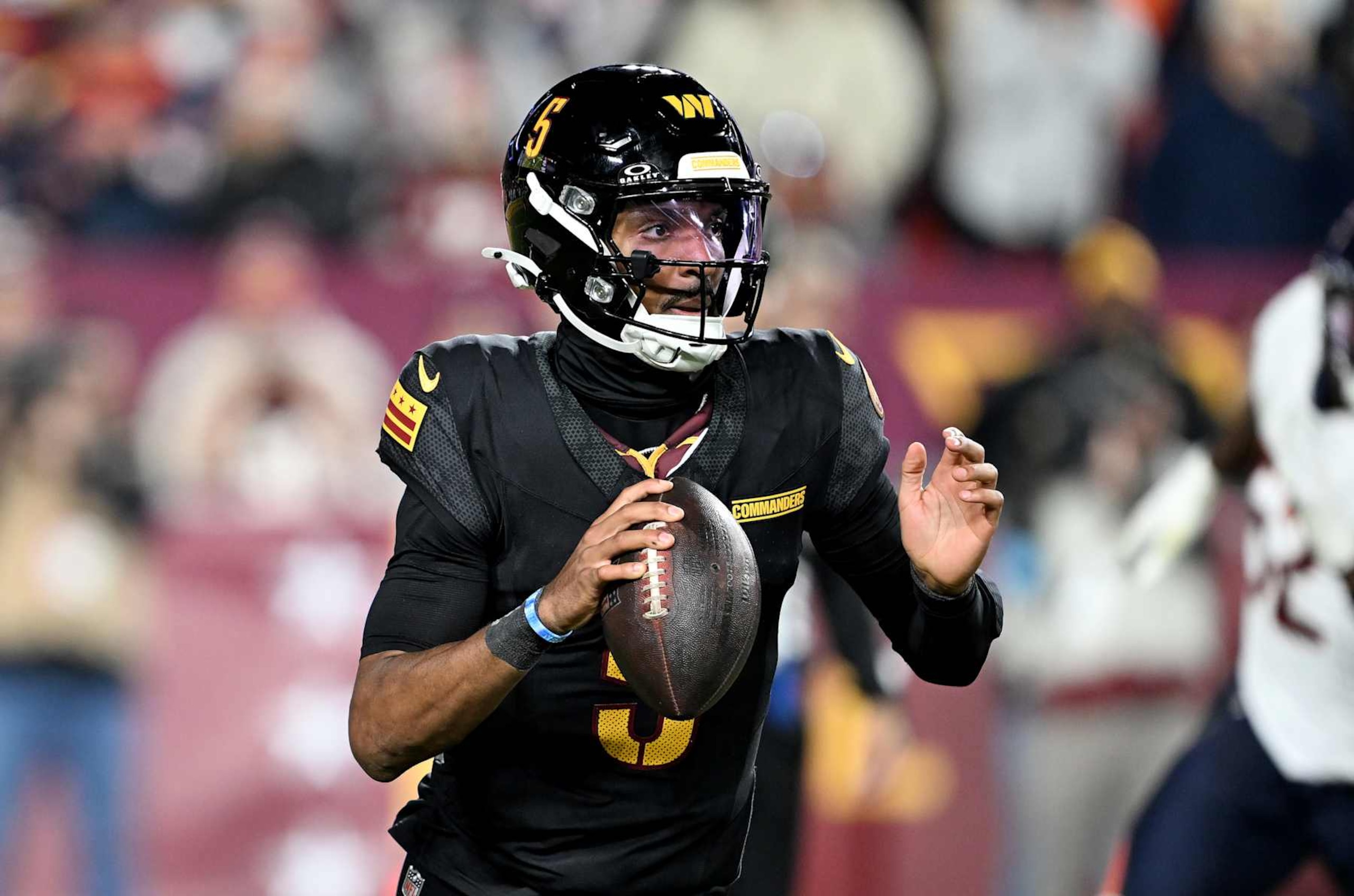 LANDOVER, MARYLAND - OCTOBER 27: Jayden Daniels #5 of the Washington Commanders drops back to pass against the Chicago Bears at Northwest Stadium on October 27, 2024 in Landover, Maryland. (Photo by G Fiume/Getty Images)