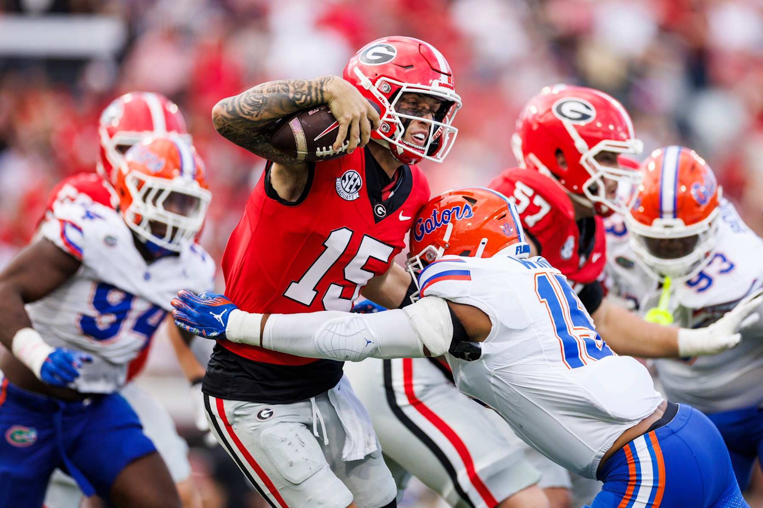 JACKSONVILLE, FLORIDA - NOVEMBER 02: Carson Beck #15 of the Georgia Bulldogs is sacked by Derek Wingo #15 of the Florida Gators during the first half of a game at EverBank Stadium on November 02, 2024 in Jacksonville, Florida. (Photo by James Gilbert/Getty Images)