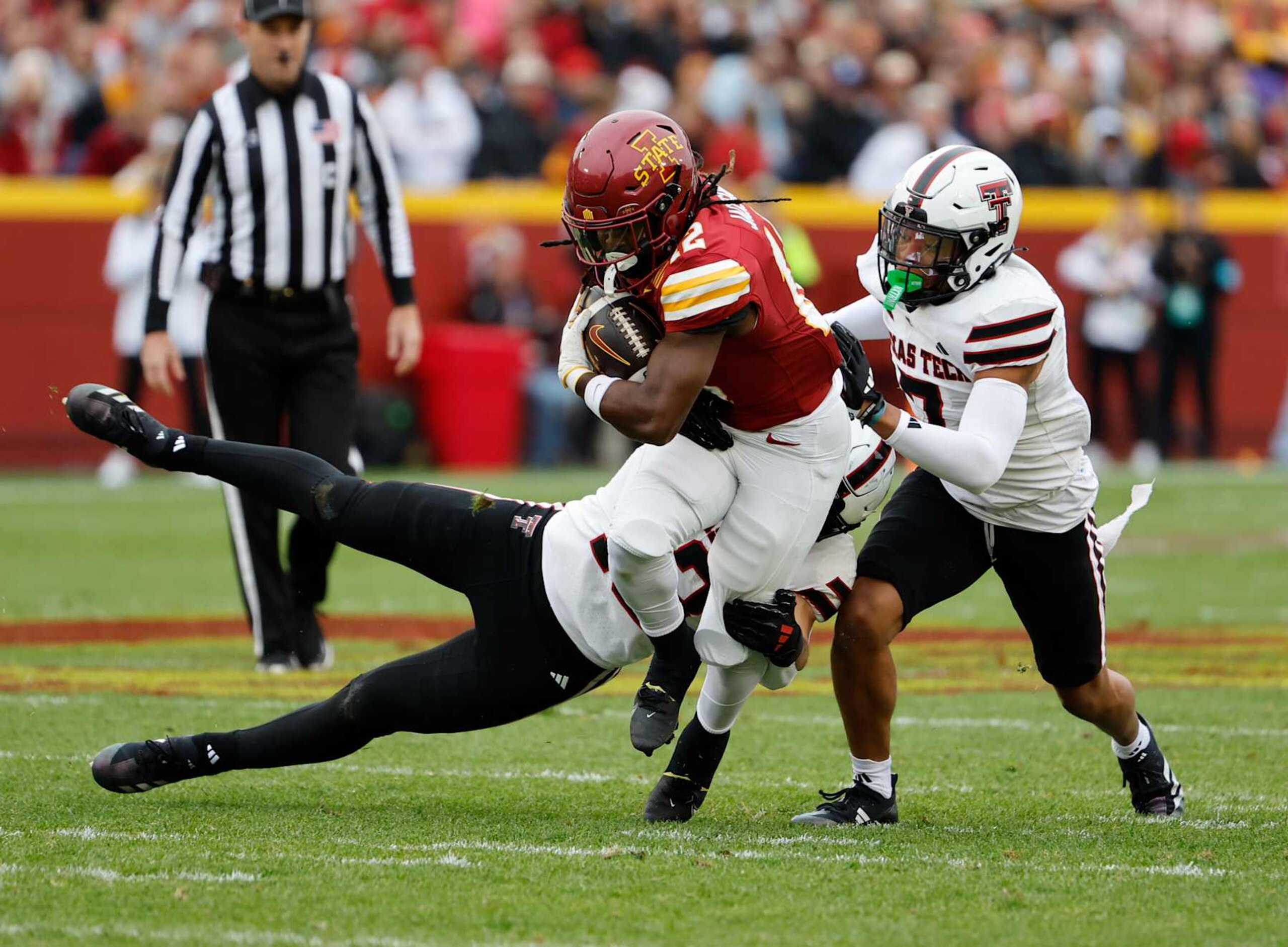 AMES, IA - NOVEMBER 02: Running back Jaylon Jackson #12 of the Iowa State Cyclones is tackled by linebacker Ben Roberts #13, and defensive back Brenden Jordan #7 of the Texas Tech Red Raiders as he rushed for yards in the first half of play at Jack Trice Stadium on November 2, 2024, in Ames, Iowa. (Photo by David Purdy/Getty Images)