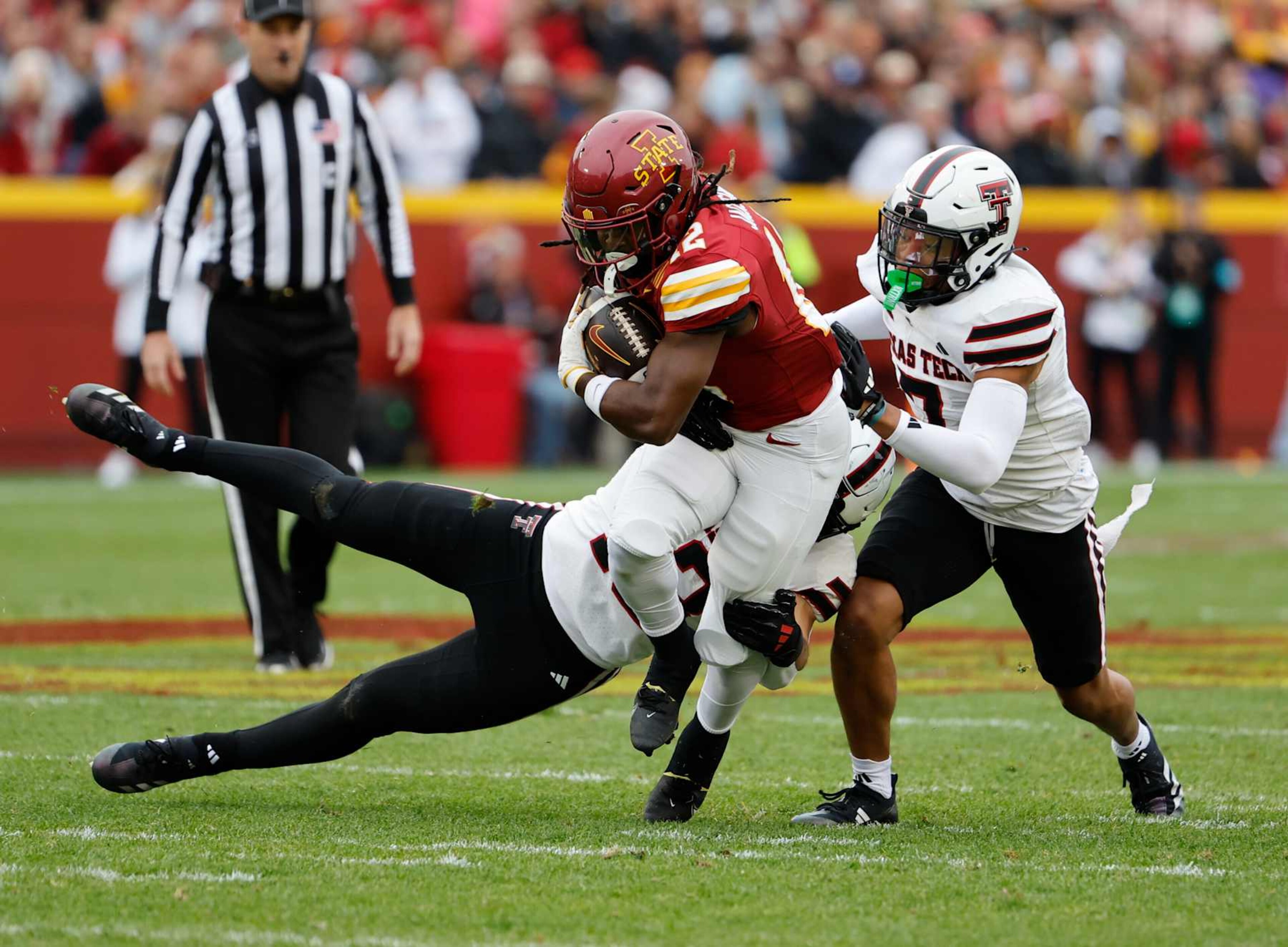 AMES, IA - NOVEMBER 02: Running back Jaylon Jackson #12 of the Iowa State Cyclones is tackled by linebacker Ben Roberts #13, and defensive back Brenden Jordan #7 of the Texas Tech Red Raiders as he rushed for yards in the first half of play at Jack Trice Stadium on November 2, 2024, in Ames, Iowa. (Photo by David Purdy/Getty Images)