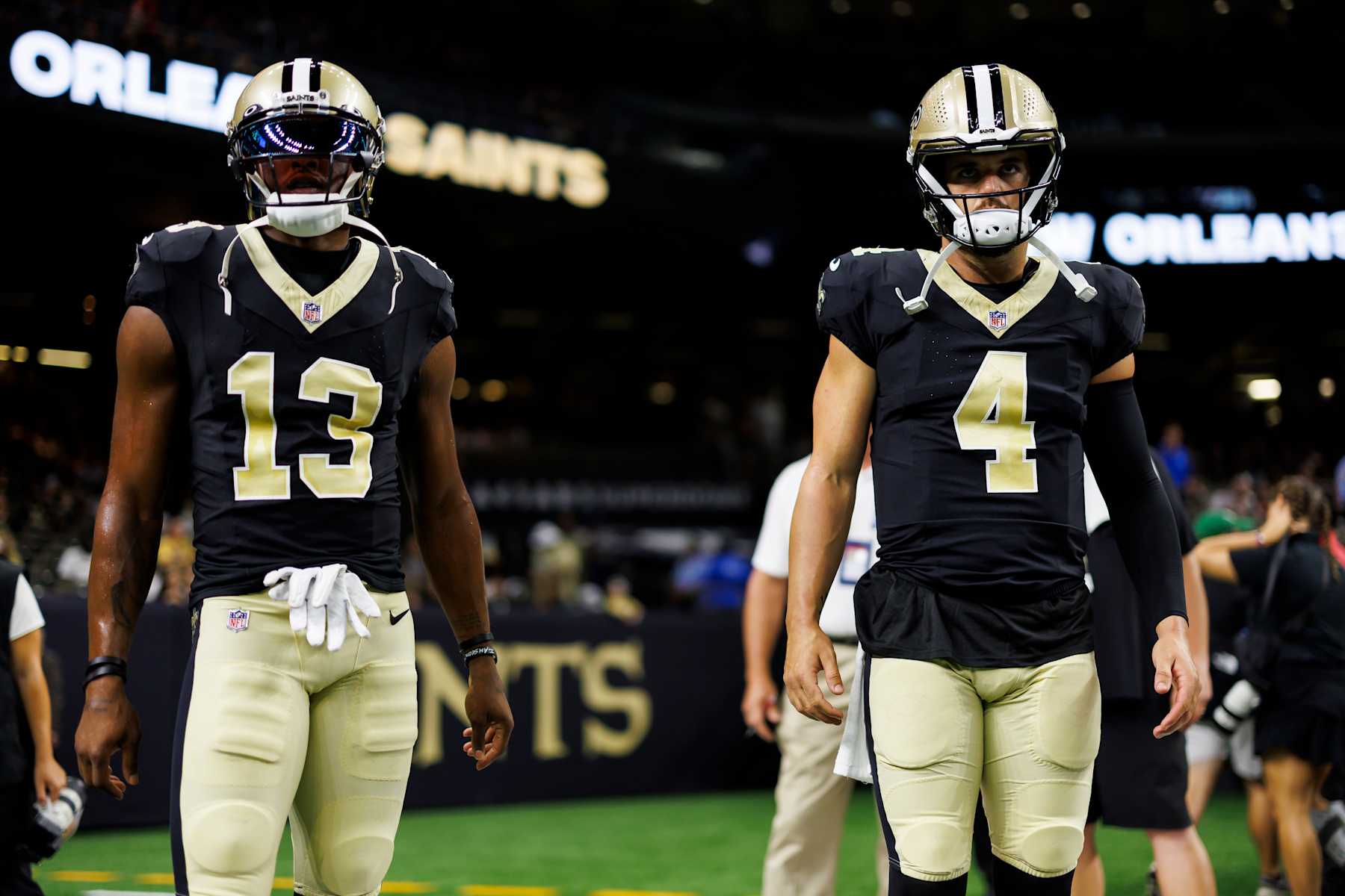 NEW ORLEANS, LOUISIANA - AUGUST 13: Michael Thomas #13 of the New Orleans Saints and Derek Carr #4 of the New Orleans Saints stand together during pregame warmups prior to an NFL preseason football game against the Kansas City Chiefs at Caesars Superdome on August 13, 2023 in New Orleans, Louisiana. (Photo by Ryan Kang/Getty Images)
