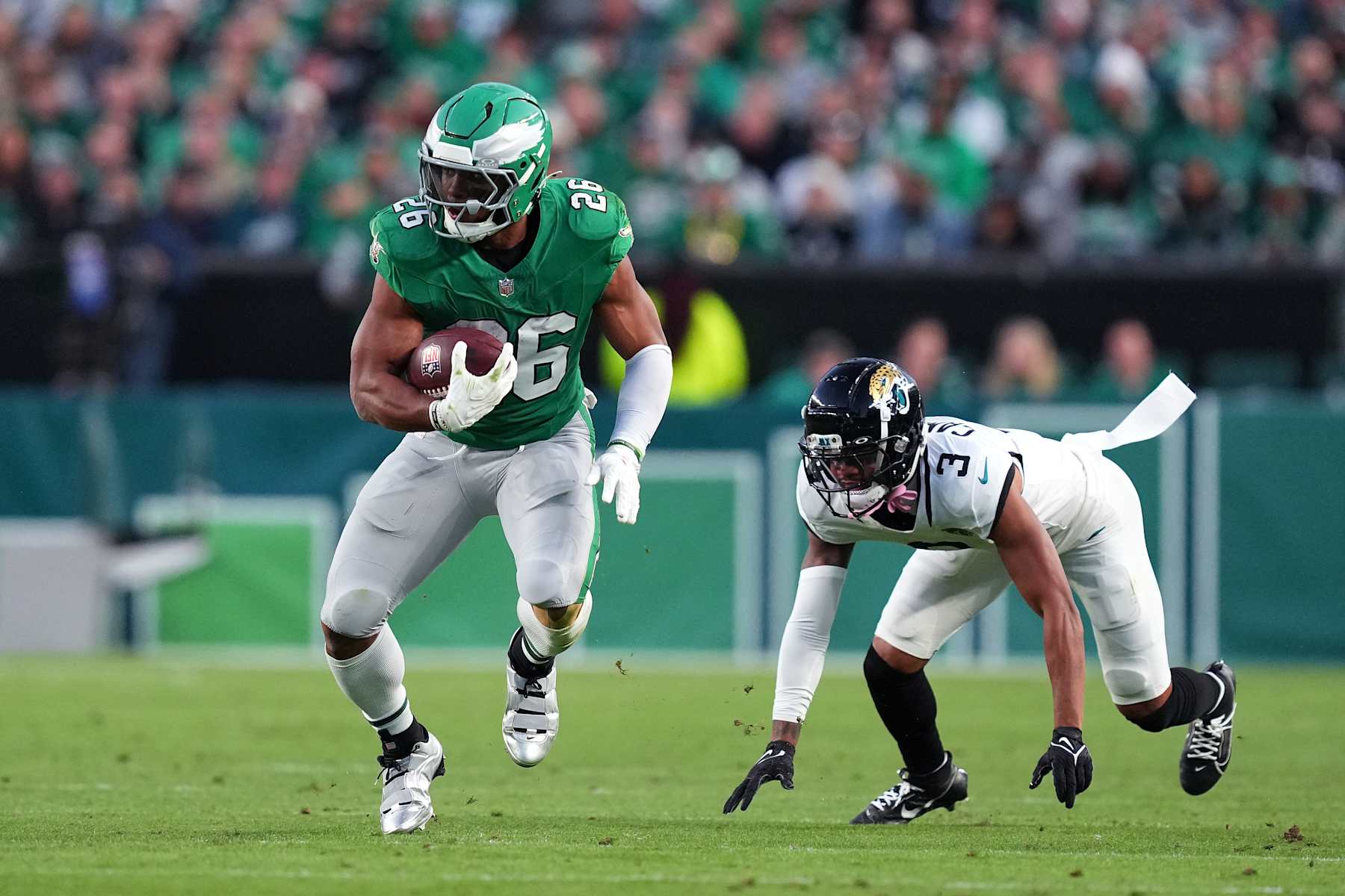 PHILADELPHIA, PENNSYLVANIA - NOVEMBER 03: Saquon Barkley #26 of the Philadelphia Eagles runs past Tyson Campbell #3 of the Jacksonville Jaguars second quarter of a game at Lincoln Financial Field on November 03, 2024 in Philadelphia, Pennsylvania. (Photo by Mitchell Leff/Getty Images)