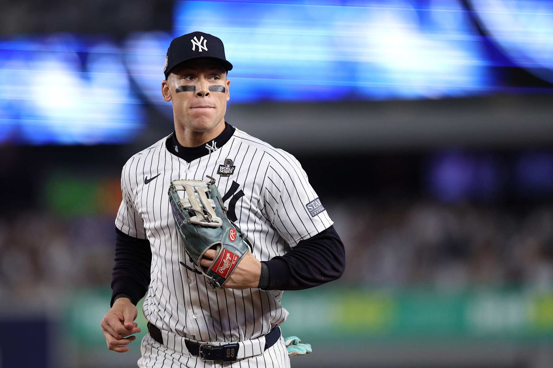 NEW YORK, NEW YORK - OCTOBER 30:  Aaron Judge #99 of the New York Yankees jogs in at the end of the inning after catching a ball hit off the bat of Freddie Freeman #5 of the Los Angeles Dodgers at the wall during the fourth inning of Game Five of the 2024 World Series at Yankee Stadium on October 30, 2024 in the Bronx borough of New York City. (Photo by Elsa/Getty Images)