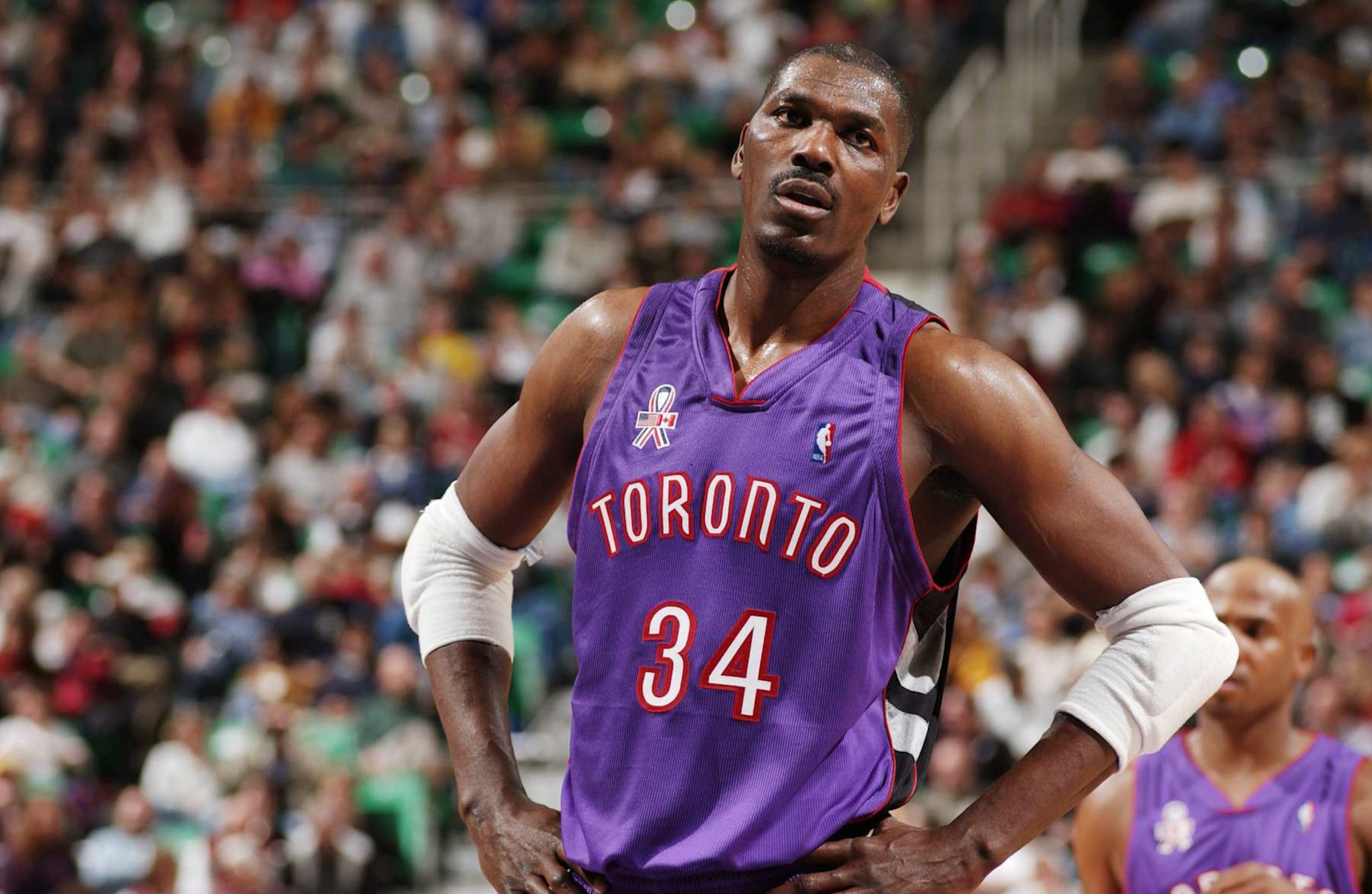 10 Nov 2001: Hakeem Olajuwon #34 of the Toronto Raptors looks on during their game against the Utah Jazz at Delta Center in Salt Lake City, UT. The Raptors won, 117-96. Mandatory Credit: Kent Horner/NBAE/Getty Images Digital Image NOTE TO USER: User expressly acknowledges and agrees that, by downloading and/or using this Photograph, User is consenting to the terms and conditions of the Getty Images License Agreement. Mandatory copyright notice: Copyright 2001 NBAE 10 Nov 2001: Hakeem Olajuwon #34 of the Toronto Raptors looks on during their game against the Utah Jazz at Delta Center in Salt Lake City, UT. The Raptors won, 117-96. Mandatory Credit: Kent Horner/NBAE/Getty Images Digital Image NOTE TO USER: User expressly acknowledges and agrees that, by downloading and/or using this Photograph, User is consenting to the terms and conditions of the Getty Images License Agreement. Mandatory copyright notice: Copyright 2001 NBAE