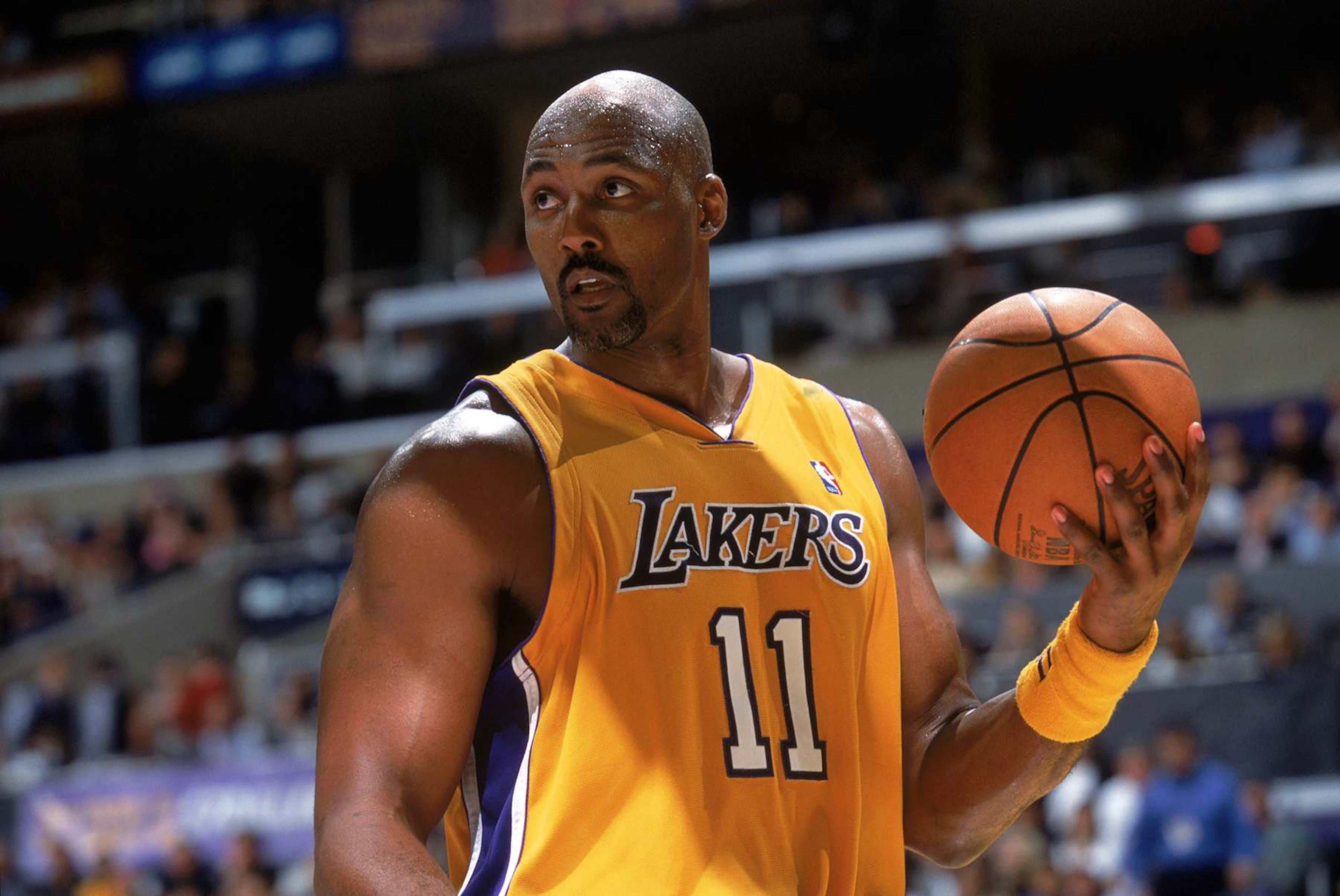 LOS ANGELES - March 15:  Karl Malone #11 of the Los Angeles Lakers holds the ball during the game against the Orlando Magic at Staples Center on March 15, 2004 in Los Angeles, California.  The Lakers won 113-110.  NOTE TO USER: User expressly acknowledges and agrees that, by downloading and/or using this Photograph, User is consenting to the terms and conditions of the Getty Images License Agreement.  (Photo by Andrew D. Bernstein/NBAE via Getty Images)
