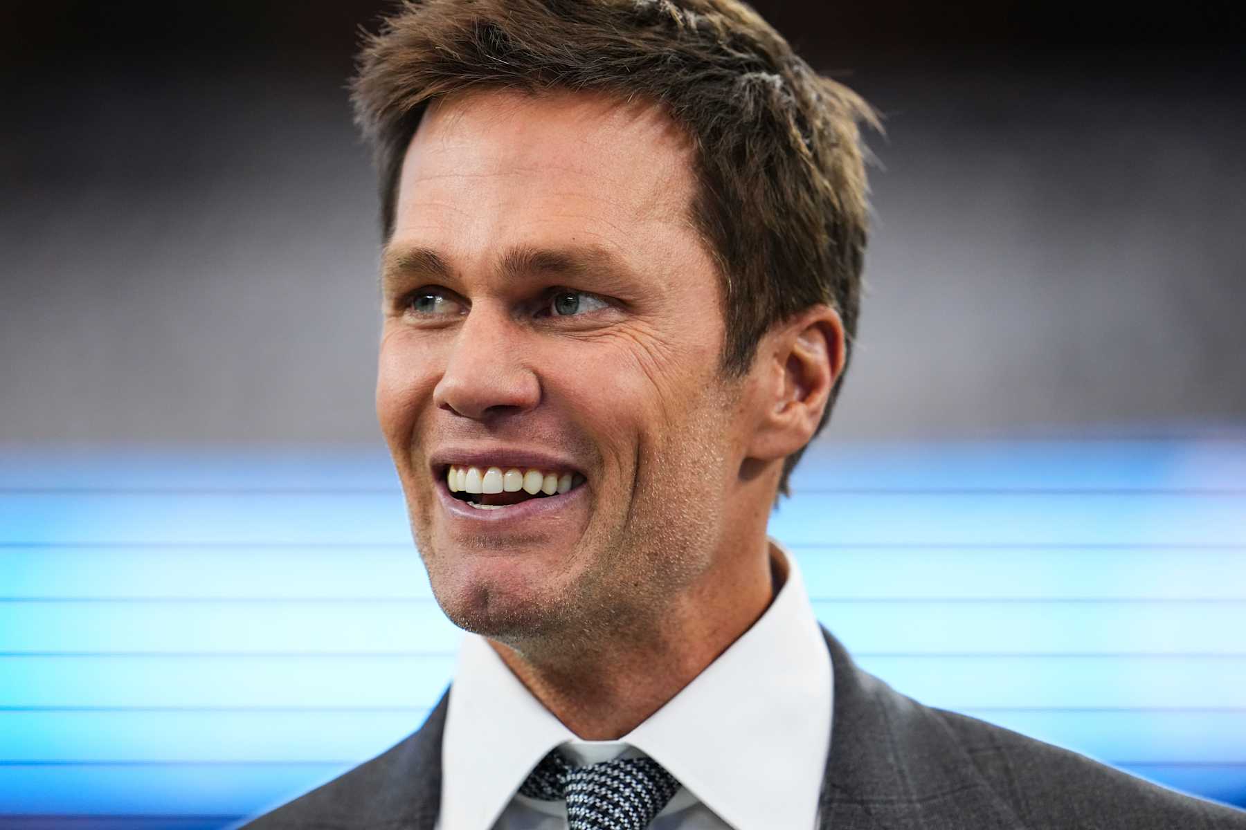 ARLINGTON, TX - OCTOBER 13:  Tom Brady looks on from the field prior to an NFL football game between the Detroit Lions and the Dallas Cowboys at AT&T Stadium on October 13, 2024 in Arlington, Texas. (Photo by Cooper Neill/Getty Images)