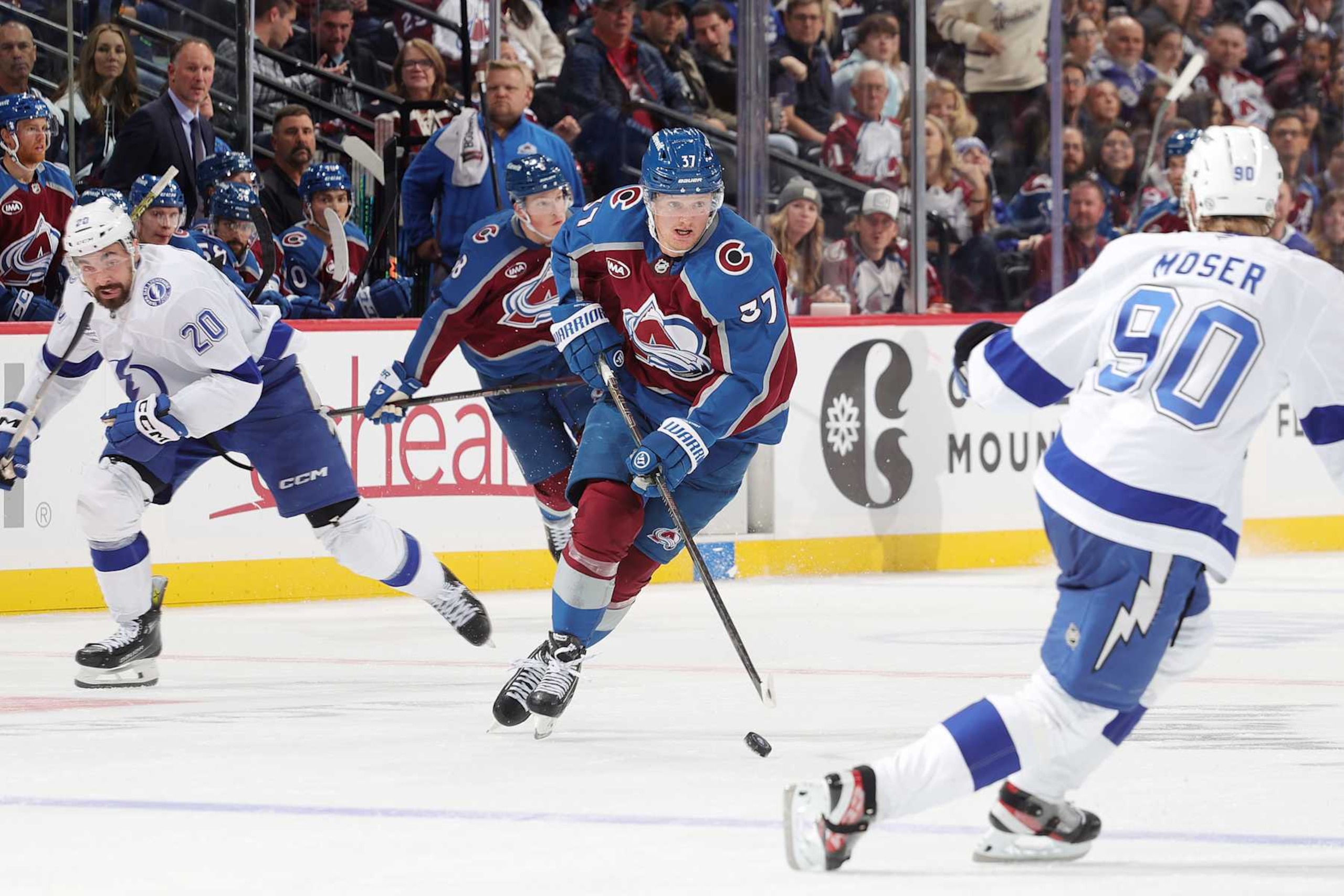 DENVER, COLORADO - OCTOBER 30: Casey Mittelstadt #37 of the Colorado Avalanche skates against J.J. Moser #90 of the Tampa Bay Lightning at Ball Arena on October 30, 2024 in Denver, Colorado. (Photo by Michael Martin/NHLI via Getty Images)