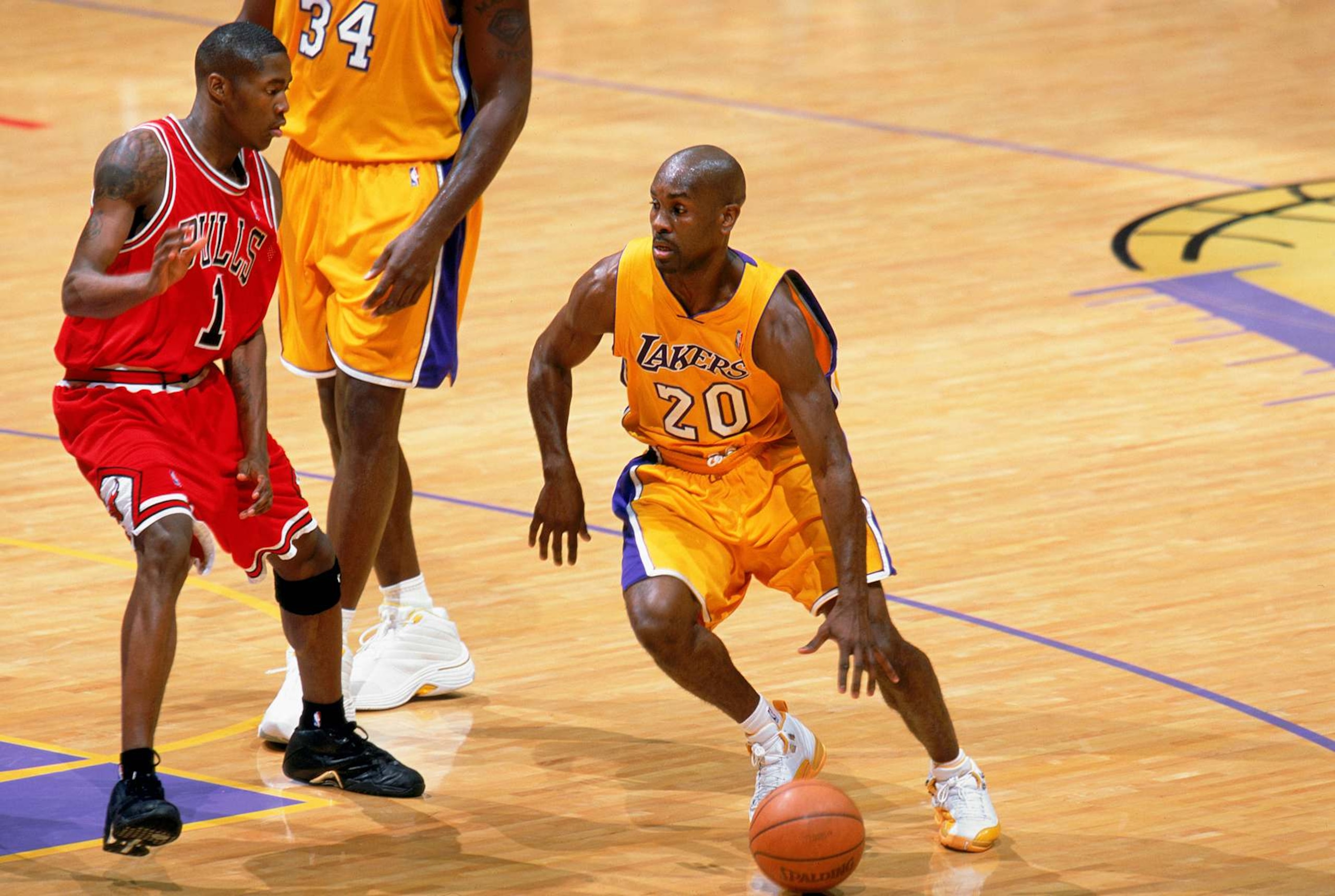 LOS ANGELES - NOVEMBER 21: Gary Payton #20 of the Los Angeles Lakers maneuvers the ball during the NBA game against the Chicago Bulls at Staples Center on November 21, 2003 in Los Angeles, California. The Lakers won 101-94. NOTE TO USER: User expressly acknowledges and agrees that, by downloading and/or using this Photograph, User is consenting to the terms and conditions of the Getty Images License Agreement. (Photo by Andrew D. Bernstein/NBAE via Getty Images) LOS ANGELES - NOVEMBER 21: Gary Payton #20 of the Los Angeles Lakers maneuvers the ball during the NBA game against the Chicago Bulls at Staples Center on November 21, 2003 in Los Angeles, California. The Lakers won 101-94. NOTE TO USER: User expressly acknowledges and agrees that, by downloading and/or using this Photograph, User is consenting to the terms and conditions of the Getty Images License Agreement. (Photo by Andrew D. Bernstein/NBAE via Getty Images)