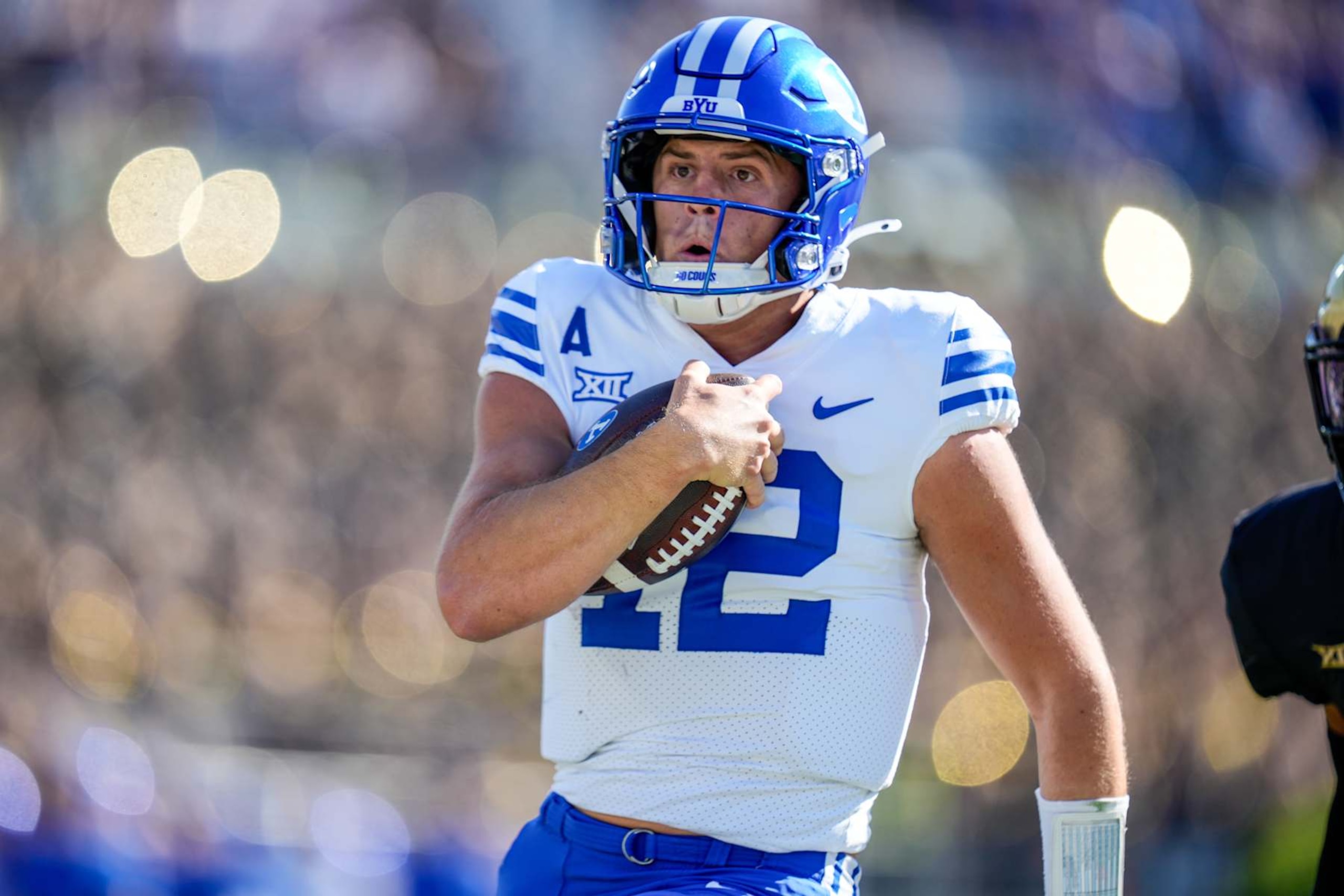 ORLANDO, FL - OCTOBER 26: Brigham Young Cougars quarterback Jake Retzlaff (12) scrambles upfield during a game between the BYU Cougars and the UCF Knights on October 26, 2024 at FBC Mortgage Stadium in Orlando, FL. (Photo by Ricky Bowden/Icon Sportswire via Getty Images)