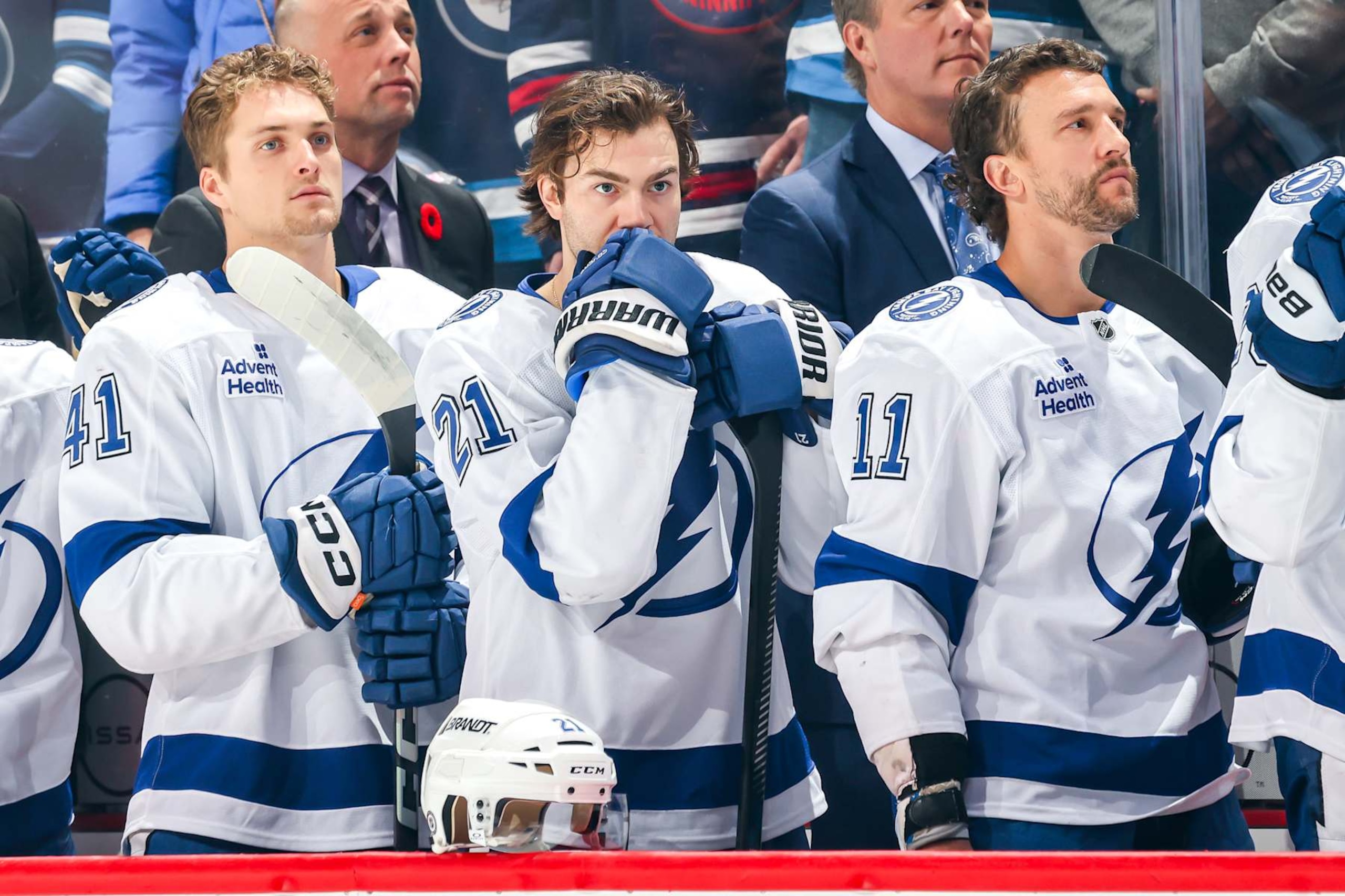 WINNIPEG, CANADA - NOVEMBER 3: Mitchell Chaffee #41, Brayden Point #21 and Luke Glendening #11 of the Tampa Bay Lightning stand on the bench during the singing of the National anthems prior to puck drop against the Winnipeg Jets at the Canada Life Centre on November 3, 2024 in Winnipeg, Manitoba, Canada. (Photo by Jonathan Kozub/NHLI via Getty Images) WINNIPEG, CANADA - NOVEMBER 3: Mitchell Chaffee #41, Brayden Point #21 and Luke Glendening #11 of the Tampa Bay Lightning stand on the bench during the singing of the National anthems prior to puck drop against the Winnipeg Jets at the Canada Life Centre on November 3, 2024 in Winnipeg, Manitoba, Canada. (Photo by Jonathan Kozub/NHLI via Getty Images)