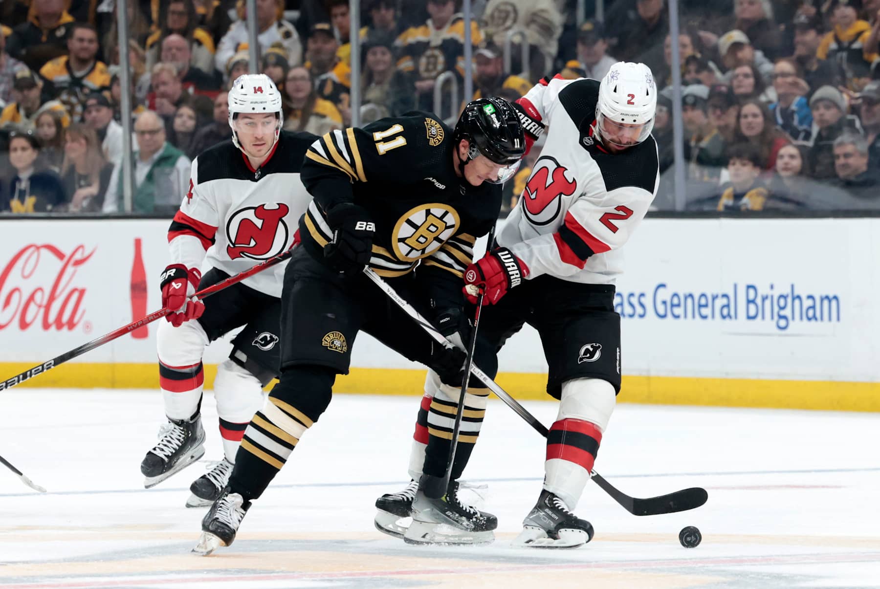 BOSTON, MA - DECEMBER 30: New Jersey Devils defenseman Brendan Smith (2) ties up Boston Bruins center Trent Frederic (11) during a game between the Boston Bruins and the New Jersey Devils on December 30, 2023, at TD Garden in Boston, Massachusetts. (Photo by Fred Kfoury III/Icon Sportswire via Getty Images)