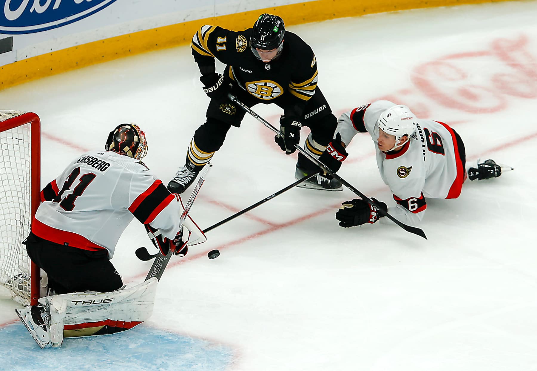 Boston, MA - April 16: Ottawa Senators goalie Anton Forsberg and defenseman Jakob Chychrun deny Boston Bruins center Trent Frederic's shot on goal in the second period. (Photo by Matthew J. Lee/The Boston Globe via Getty Images)