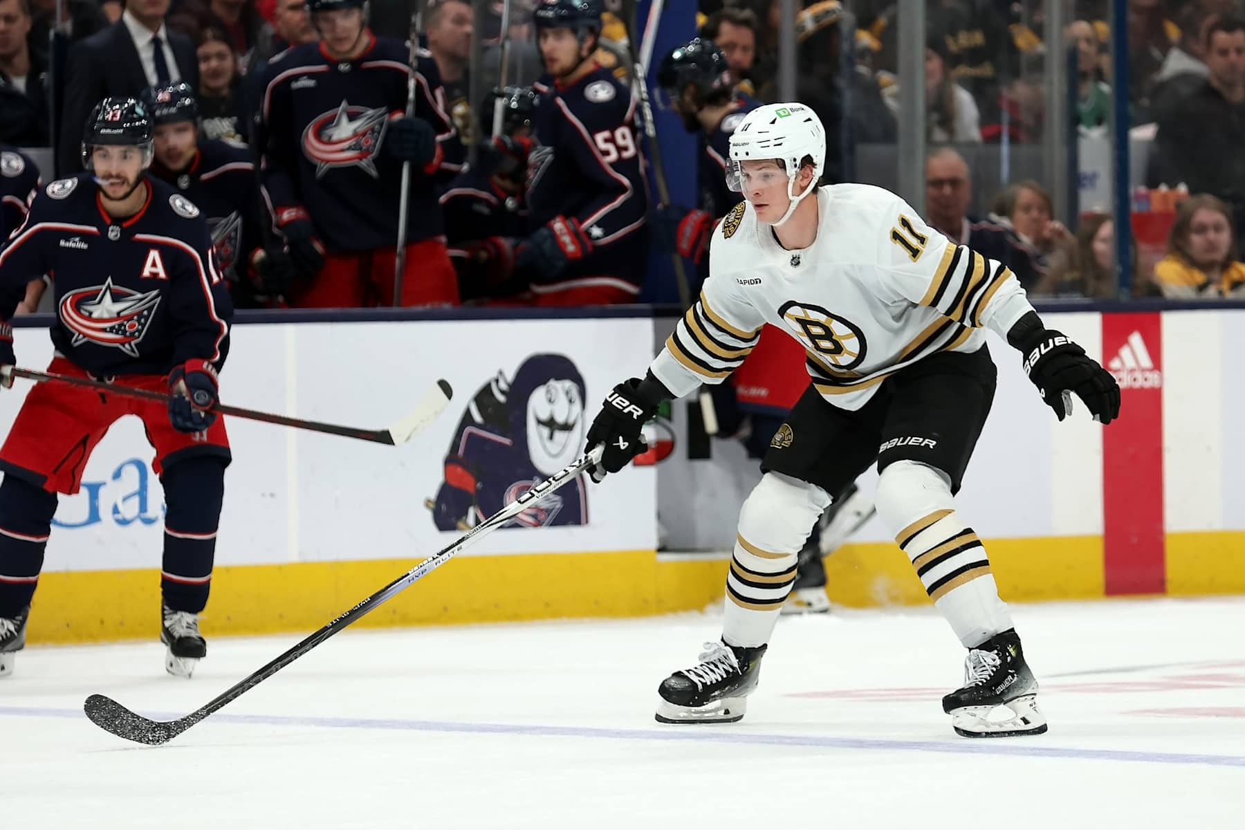 COLUMBUS, OHIO - JANUARY 2:  Trent Frederic #11 of the Boston Bruins skates after the puck during the game against the Columbus Blue Jackets at Nationwide Arena on January 2, 2024 in Columbus, Ohio. Boston defeated Columbus 4-1. (Photo by Kirk Irwin/Getty Images)