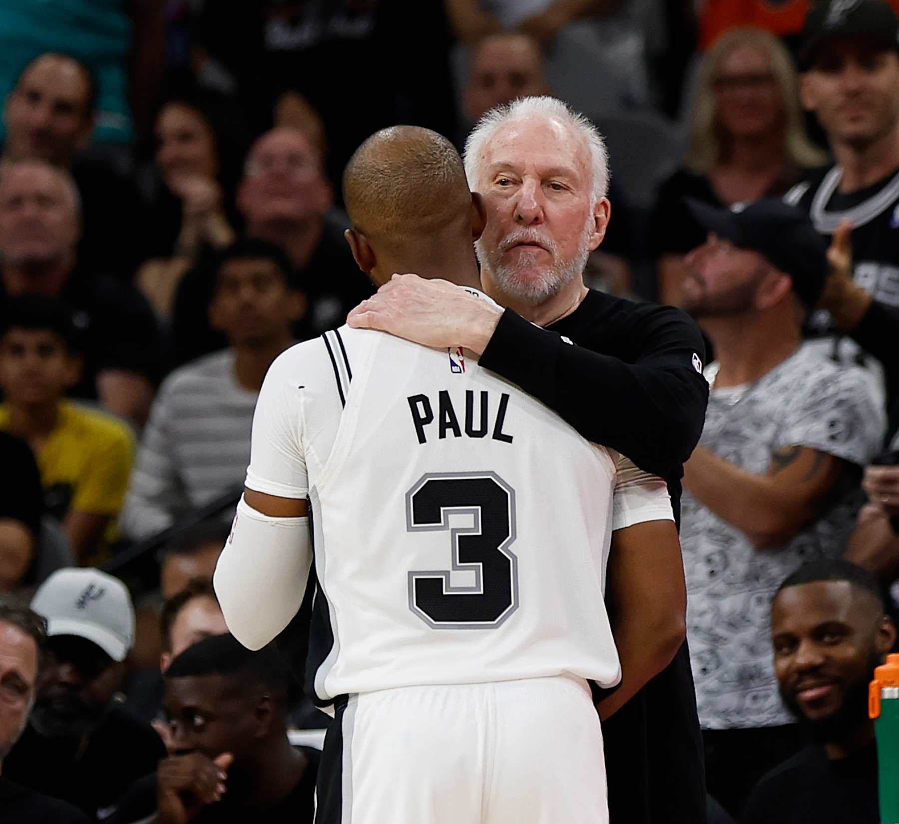 SAN ANTONIO, TX - OCTOBER 26:  Chris Paul #3 of the San Antonio Spurs gets a hug from Head coach Gregg Popovich after an assist against the Houston Rockets in the first half at Frost Bank Center on October 26, 2024 in San Antonio, Texas. NOTE TO USER: User expressly acknowledges and agrees that, by downloading and or using this photograph, User is consenting to terms and conditions of the Getty Images License Agreement. (Photo by Ronald Cortes/Getty Images)