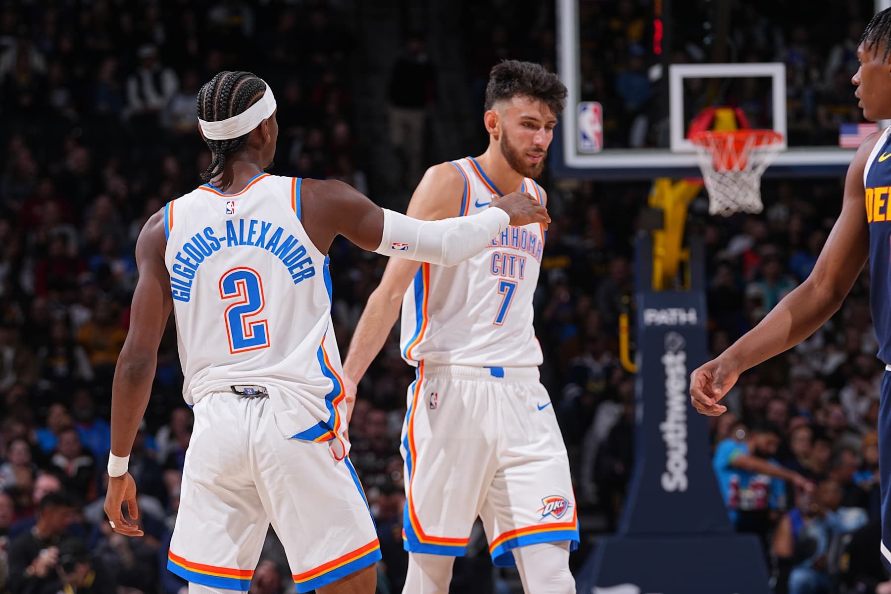 DENVER, CO - NOVEMBER 6:  Shai Gilgeous-Alexander #2 and Chet Holmgren #7 of the Oklahoma City Thunder high five during the game against the Denver Nuggets during a regular season game on November 6, 2024 at Ball Arena in Denver, Colorado. NOTE TO USER: User expressly acknowledges and agrees that, by downloading and/or using this Photograph, user is consenting to the terms and conditions of the Getty Images License Agreement. Mandatory Copyright Notice: Copyright 2024 NBAE (Photo by Bart Young/NBAE via Getty Images)