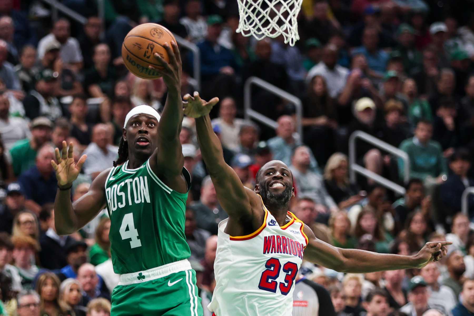 BOSTON, MA - NOVEMBER 6:  Jrue Holiday #4 of the Boston Celtics drives to the basket against Draymond Green #23 of the Golden State Warriors in the fourth quarter at TD Garden on NOVEMBER 6::, 2024 in Boston, Massachusetts. NOTE TO USER: User expressly acknowledges and agrees that, by downloading and or using this photograph, User is consenting to the terms and conditions of the Getty Images License Agreement. (Photo by Adam Glanzman/Getty Images)