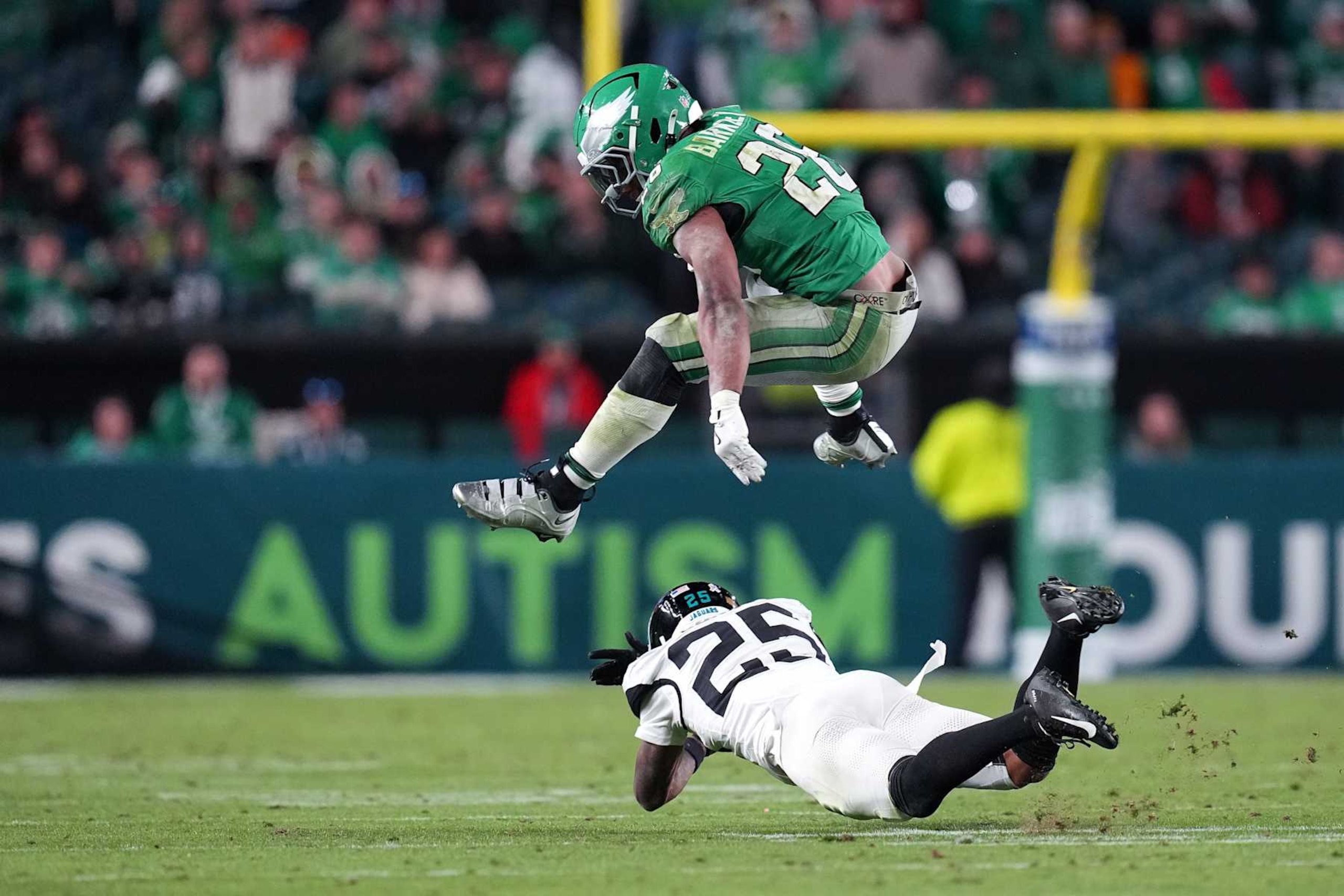 PHILADELPHIA, PENNSYLVANIA - NOVEMBER 03: Saquon Barkley #26 of the Philadelphia Eagles hurdles Ronald Darby #25 of the Jacksonville Jaguars fourth quarter at Lincoln Financial Field on November 03, 2024 in Philadelphia, Pennsylvania. (Photo by Mitchell Leff/Getty Images)