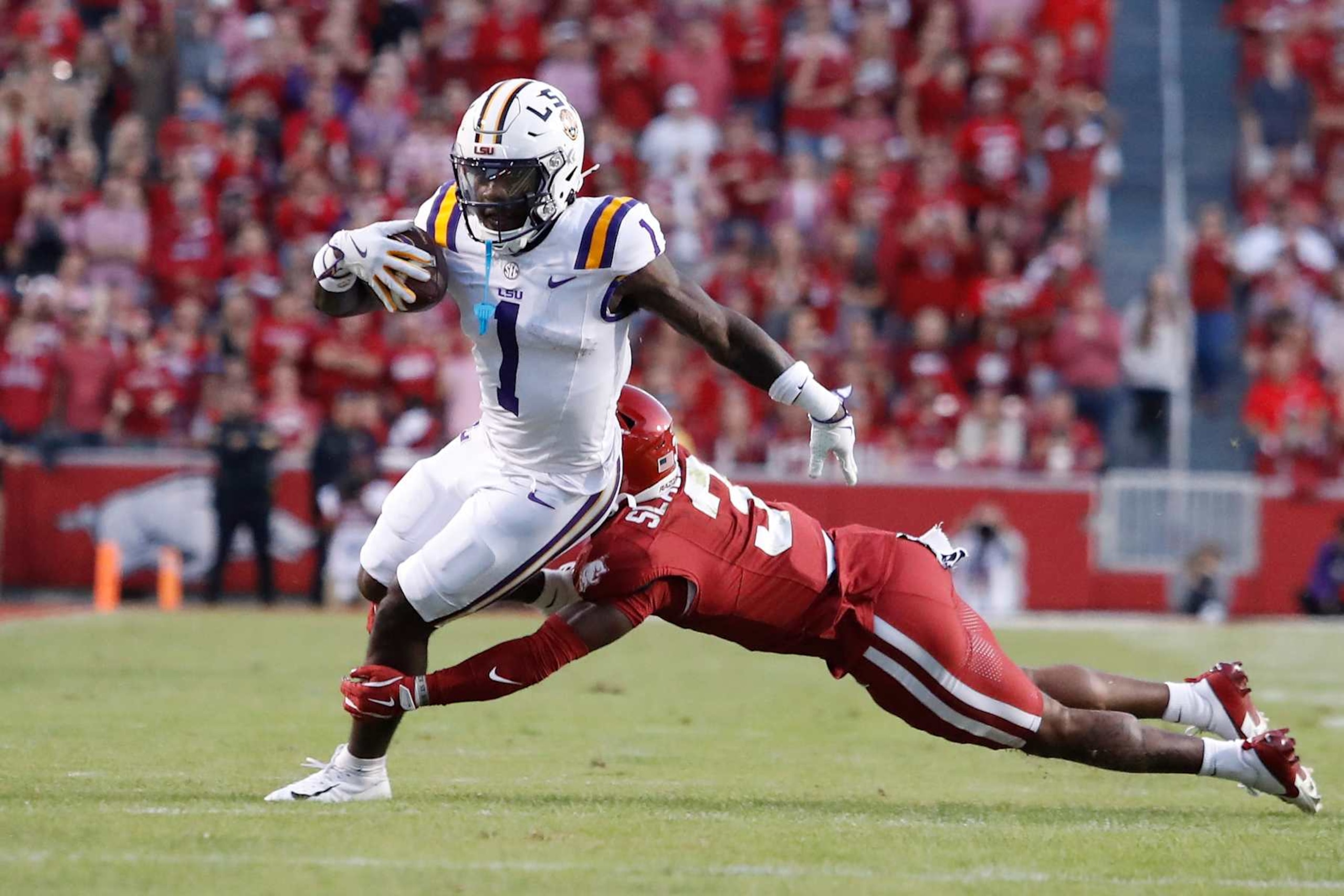 FAYETTEVILLE, AR - OCTOBER 19: LSU Tigers wide receiver Aaron Anderson (1) attempts to elude the tackle of Arkansas Razorbacks defensive back Doneiko Slaughter (3) during the college football game between the LSU Tigers and Arkansas Razorbacks on October 19, 2024, at Donald W. Reynolds Razorback Stadium in Fayetteville, Arkansas. (Photo by Andy Altenburger/Icon Sportswire via Getty Images) FAYETTEVILLE, AR - OCTOBER 19: LSU Tigers wide receiver Aaron Anderson (1) attempts to elude the tackle of Arkansas Razorbacks defensive back Doneiko Slaughter (3) during the college football game between the LSU Tigers and Arkansas Razorbacks on October 19, 2024, at Donald W. Reynolds Razorback Stadium in Fayetteville, Arkansas. (Photo by Andy Altenburger/Icon Sportswire via Getty Images)