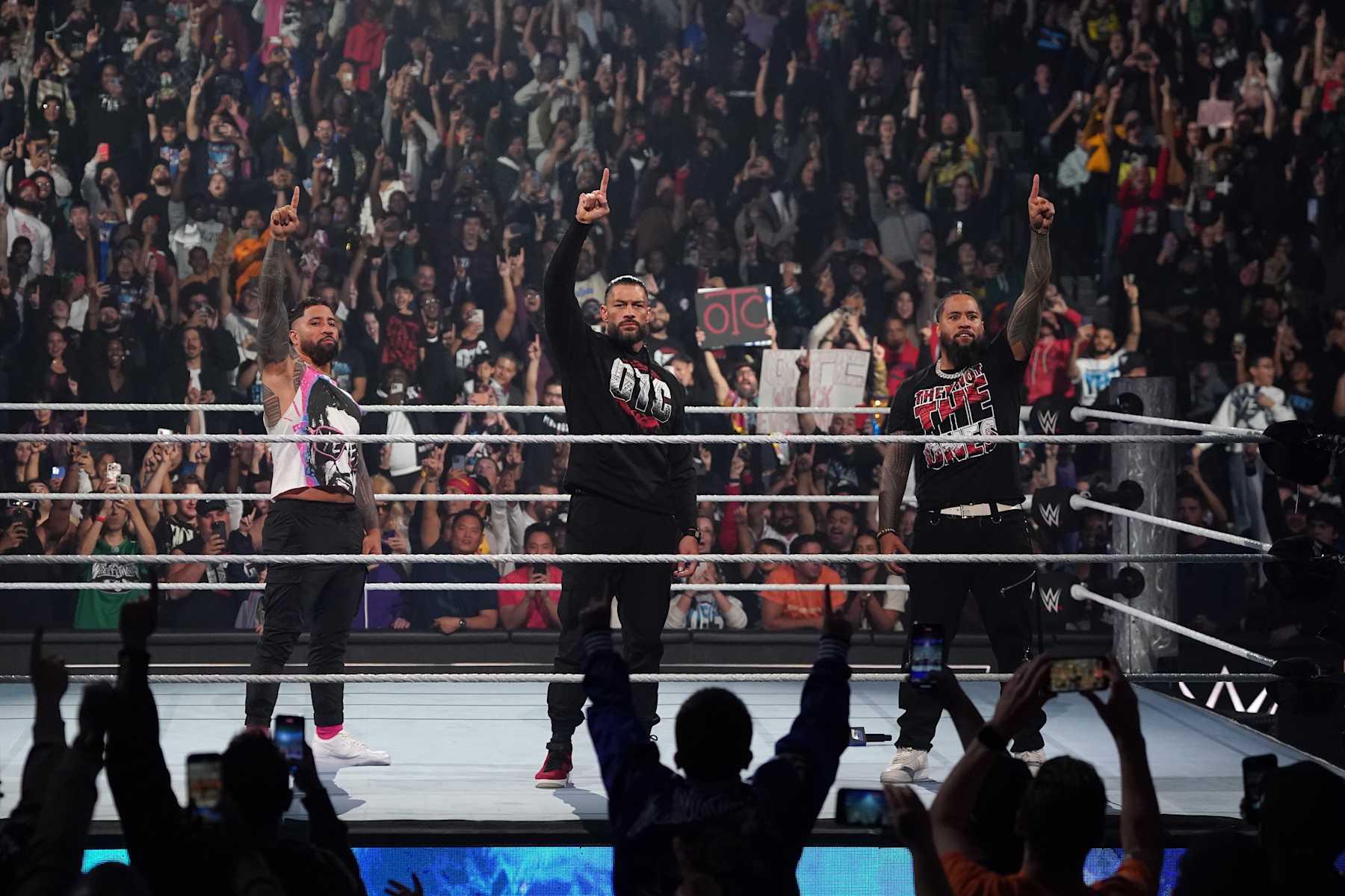 NEW YORK, NEW YORK - NOVEMBER 1: (L-R) Jey Uso, Roman Reigns and Jimmy Uso make the 'We the Ones' gesture as they stand united in the ring during WWE SmackDown at Barclays Center on November 1, 2024 in New York City.  (Photo by WWE/Getty Images)