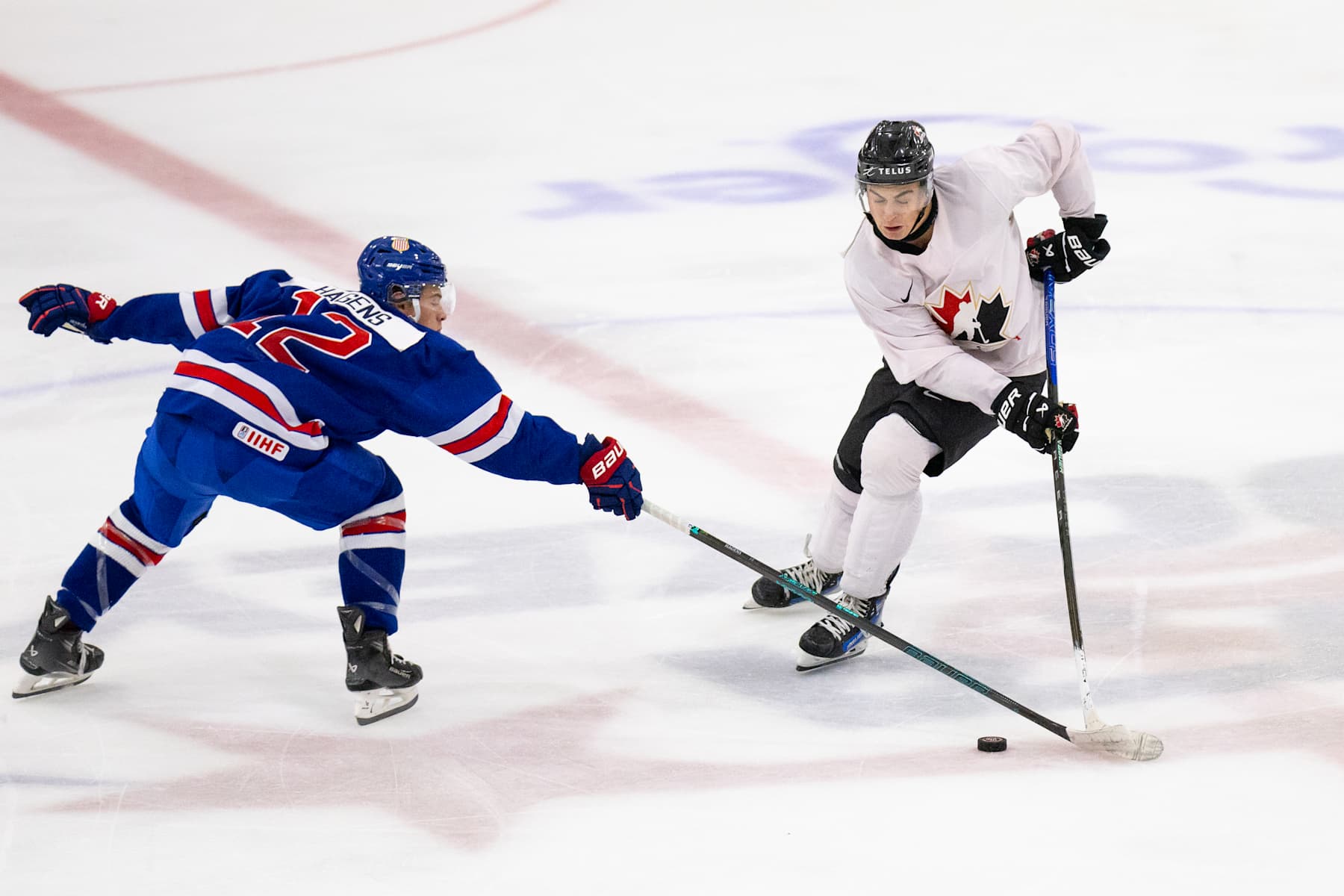 PLYMOUTH, MI - AUGUST 3: Porter Martone #19 of Team Canada makes a move with the puck to get past James Hagens #12 of Team USA during the 2024 World Junior Summer Showcase between Canada and USA at USA Hockey Arena on August 3, 2024 in Plymouth, Michigan. (Photo by Michael Miller/ISI Photos/Getty Images)