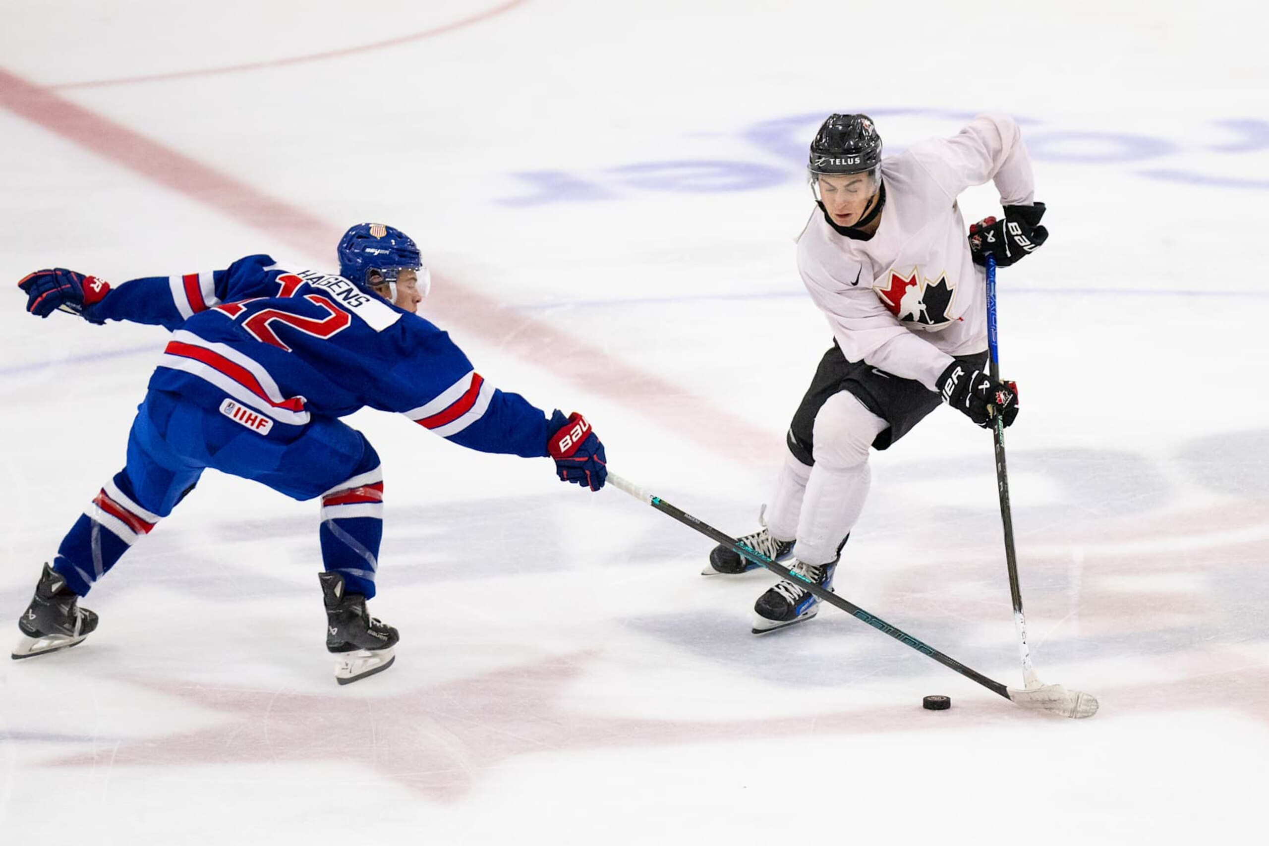 PLYMOUTH, MI - AUGUST 3: Porter Martone #19 of Team Canada makes a move with the puck to get past James Hagens #12 of Team USA during the 2024 World Junior Summer Showcase between Canada and USA at USA Hockey Arena on August 3, 2024 in Plymouth, Michigan. (Photo by Michael Miller/ISI Photos/Getty Images)