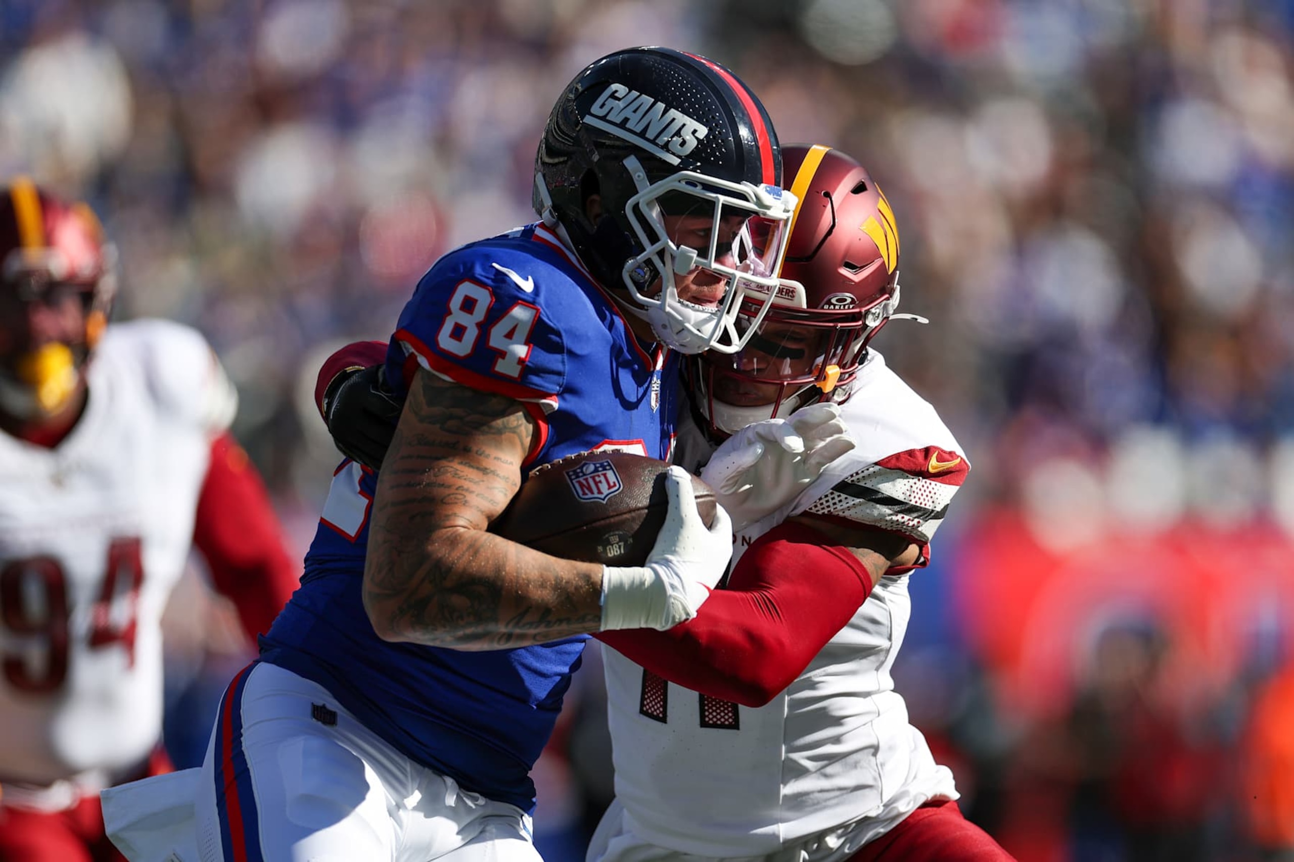 EAST RUTHERFORD, NEW JERSEY - NOVEMBER 03: Theo Johnson #84 of the New York Giants is tackled by Jeremy Chinn #11 of the Washington Commanders during the first quarter at MetLife Stadium on November 03, 2024 in East Rutherford, New Jersey. (Photo by Luke Hales/Getty Images)