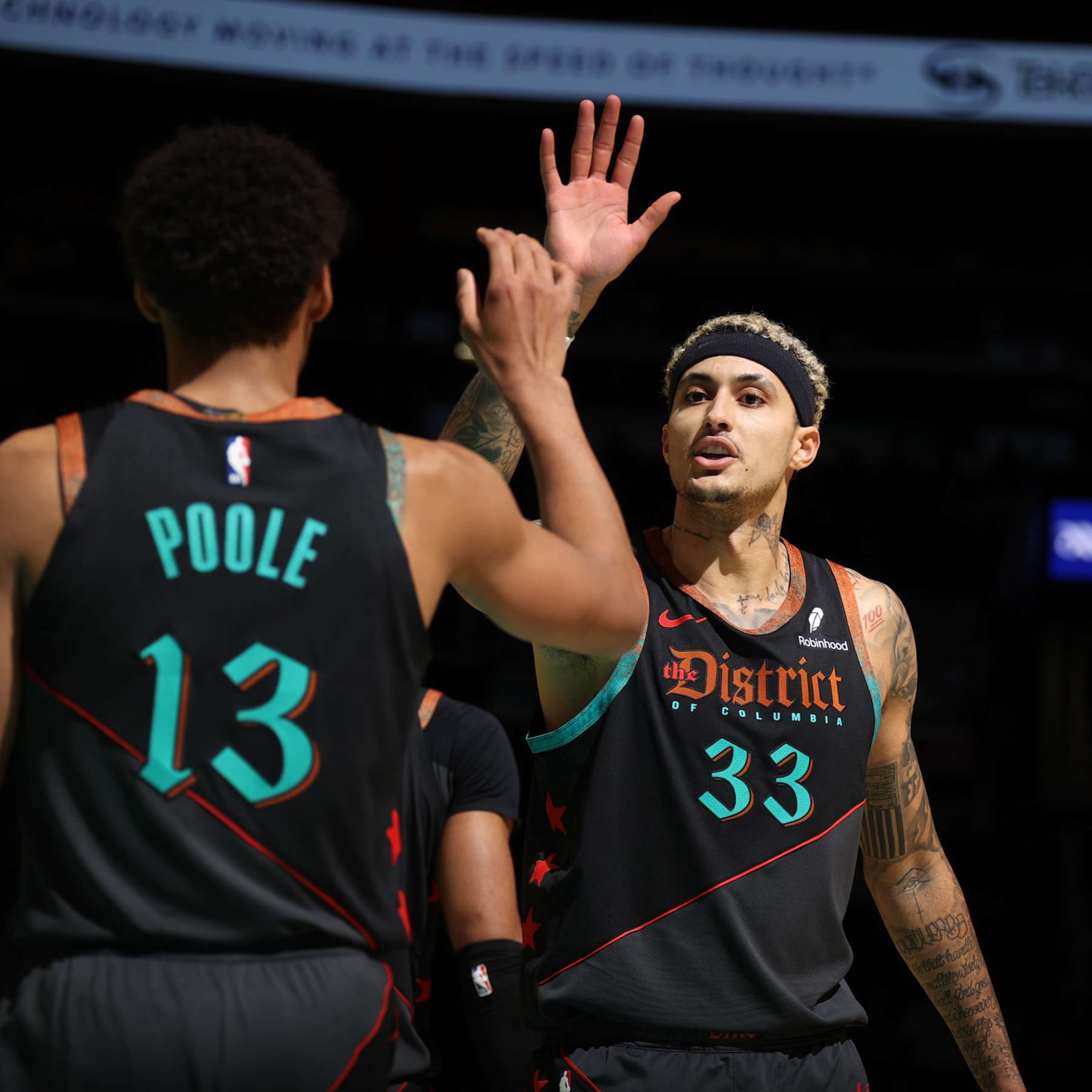 WASHINGTON, DC -  DECEMBER 15: Kyle Kuzma #33 of the Washington Wizards high fives Jordan Poole #13 of the Washington Wizards during the game against the Indiana Pacers on December 15, 2023 at Capital One Arena in Washington, DC. NOTE TO USER: User expressly acknowledges and agrees that, by downloading and or using this Photograph, user is consenting to the terms and conditions of the Getty Images License Agreement. Mandatory Copyright Notice: Copyright 2023 NBAE (Photo by Stephen Gosling/NBAE via Getty Images)