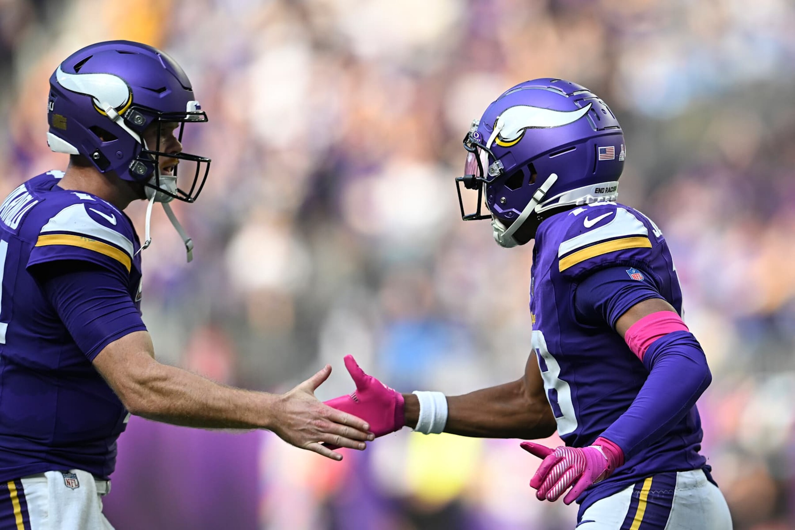 MINNEAPOLIS, MINNESOTA - OCTOBER 20: Justin Jefferson #18 of the Minnesota Vikings high-fives Sam Darnold #14 after a touchdown in the third quarter of a game against the Detroit Lions at U.S. Bank Stadium on October 20, 2024 in Minneapolis, Minnesota. (Photo by Stephen Maturen/Getty Images)