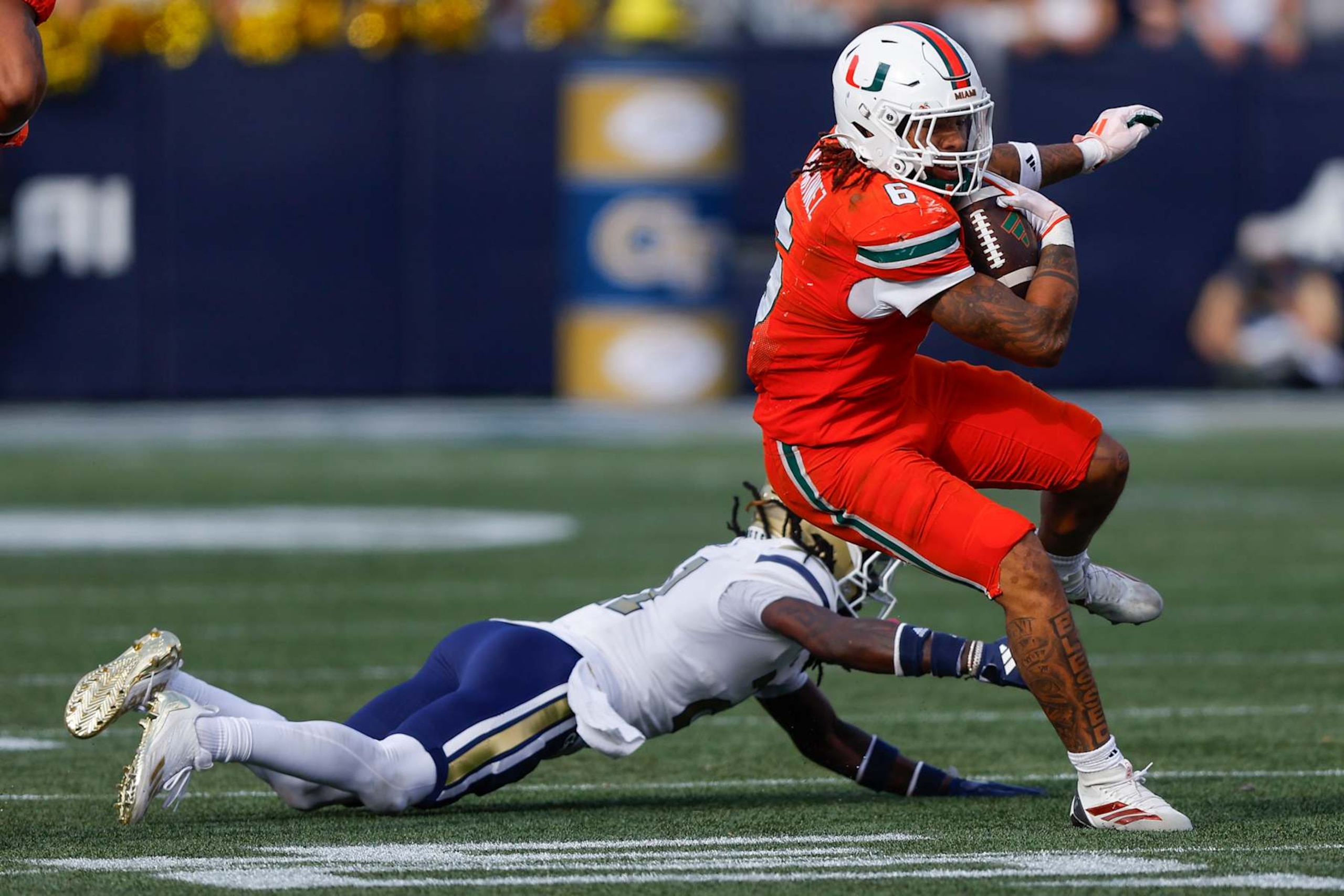 ATLANTA, GEORGIA - NOVEMBER 9: Damien Martinez #6 of the Miami Hurricanes breaks a tackle during the fourth quarter against the Georgia Tech Yellow Jackets at Bobby Dodd Stadium on November 9, 2024 in Atlanta, Georgia. (Photo by Todd Kirkland/Getty Images) ATLANTA, GEORGIA - NOVEMBER 9: Damien Martinez #6 of the Miami Hurricanes breaks a tackle during the fourth quarter against the Georgia Tech Yellow Jackets at Bobby Dodd Stadium on November 9, 2024 in Atlanta, Georgia. (Photo by Todd Kirkland/Getty Images)