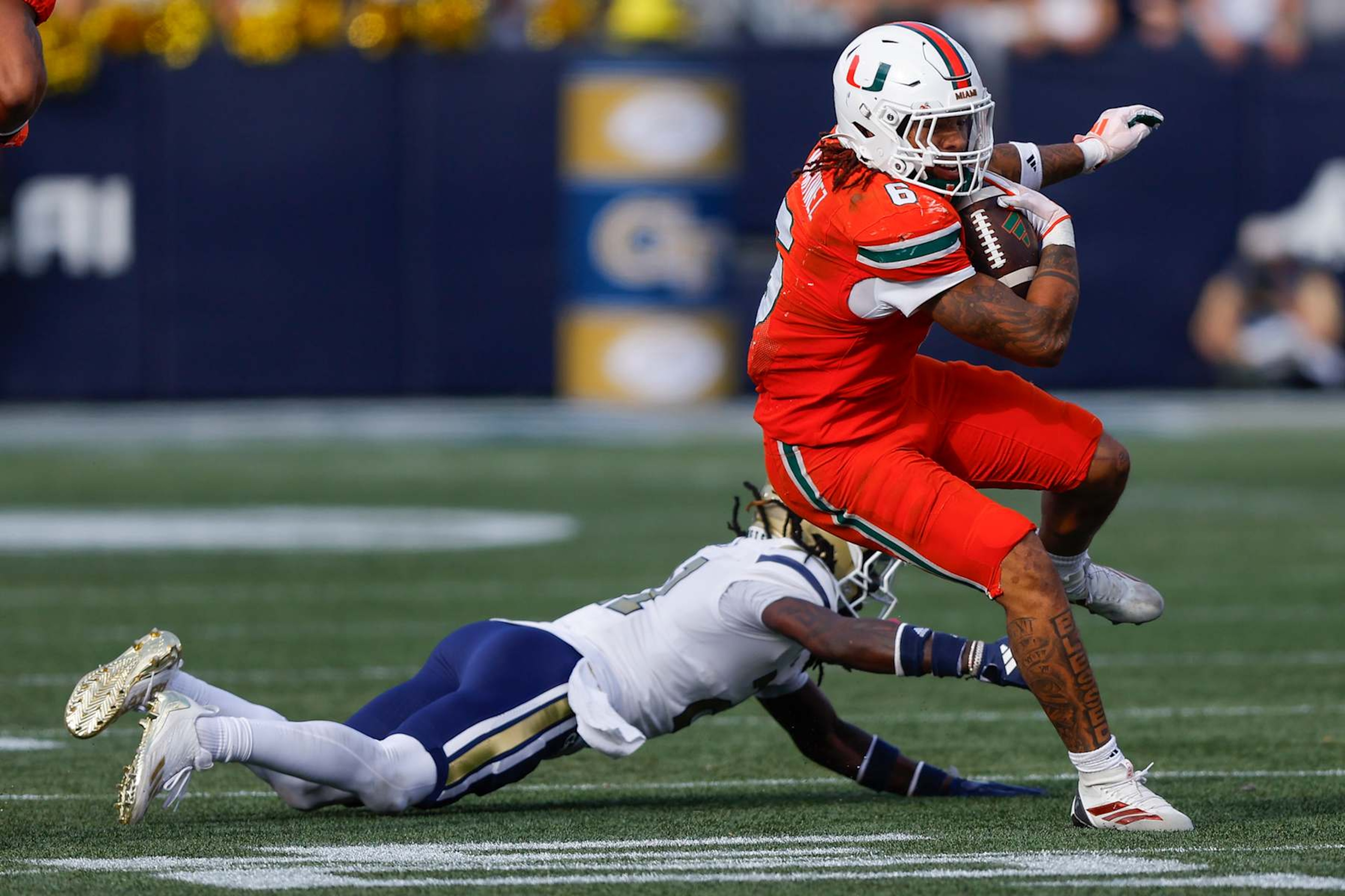 ATLANTA, GEORGIA - NOVEMBER 9: Damien Martinez #6 of the Miami Hurricanes breaks a tackle during the fourth quarter against the Georgia Tech Yellow Jackets at Bobby Dodd Stadium on November 9, 2024 in Atlanta, Georgia. (Photo by Todd Kirkland/Getty Images) ATLANTA, GEORGIA - NOVEMBER 9: Damien Martinez #6 of the Miami Hurricanes breaks a tackle during the fourth quarter against the Georgia Tech Yellow Jackets at Bobby Dodd Stadium on November 9, 2024 in Atlanta, Georgia. (Photo by Todd Kirkland/Getty Images)