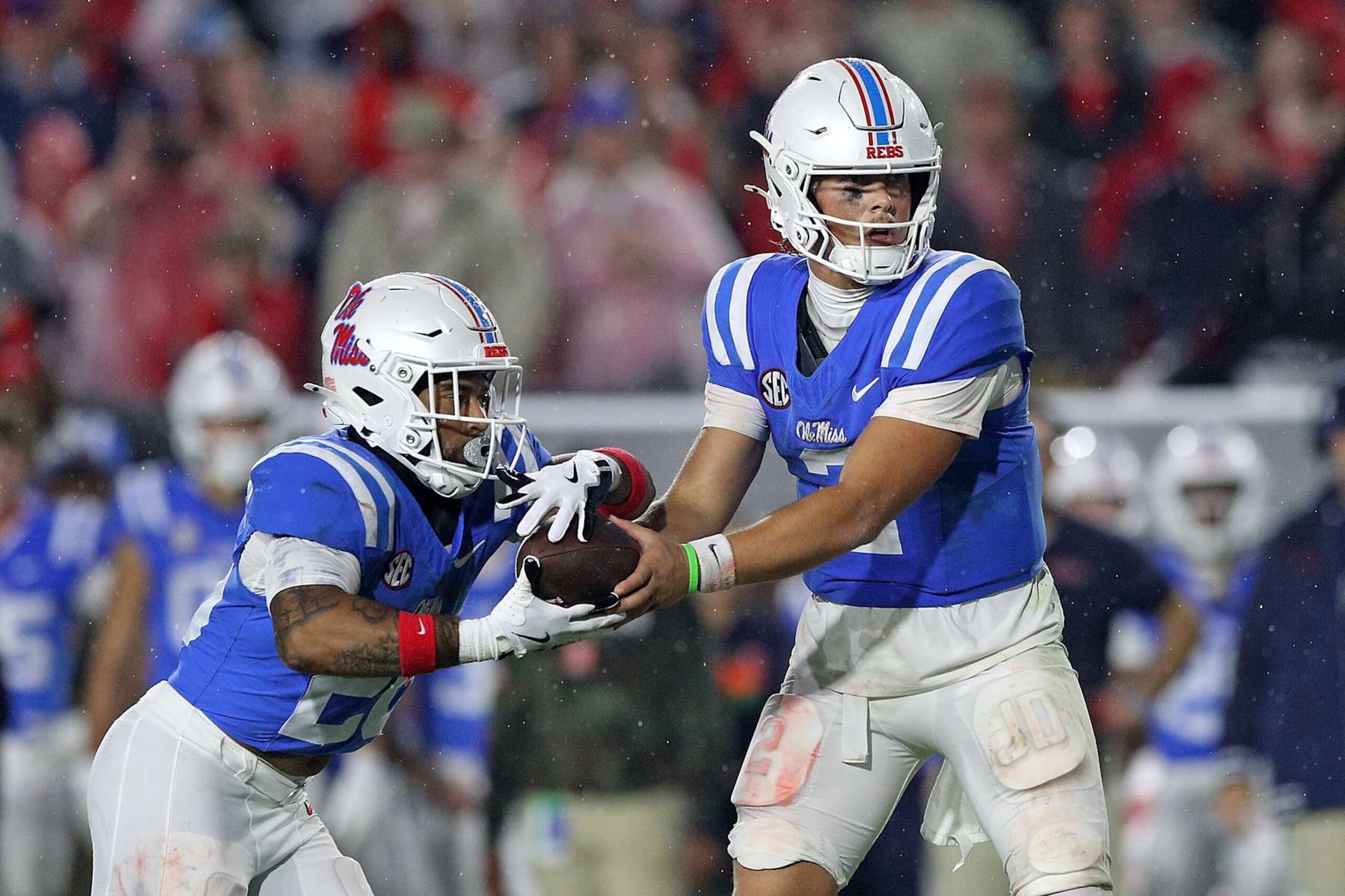 OXFORD, MISSISSIPPI - NOVEMBER 09: Jaxson Dart #2 of the Mississippi Rebels hands off to Ulysses Bentley IV #24 during the second half against the Georgia Bulldogs at Vaught-Hemingway Stadium on November 09, 2024 in Oxford, Mississippi. Ole Miss defeated Georgia 28-10. (Photo by Justin Ford/Getty Images) OXFORD, MISSISSIPPI - NOVEMBER 09: Jaxson Dart #2 of the Mississippi Rebels hands off to Ulysses Bentley IV #24 during the second half against the Georgia Bulldogs at Vaught-Hemingway Stadium on November 09, 2024 in Oxford, Mississippi. Ole Miss defeated Georgia 28-10. (Photo by Justin Ford/Getty Images)