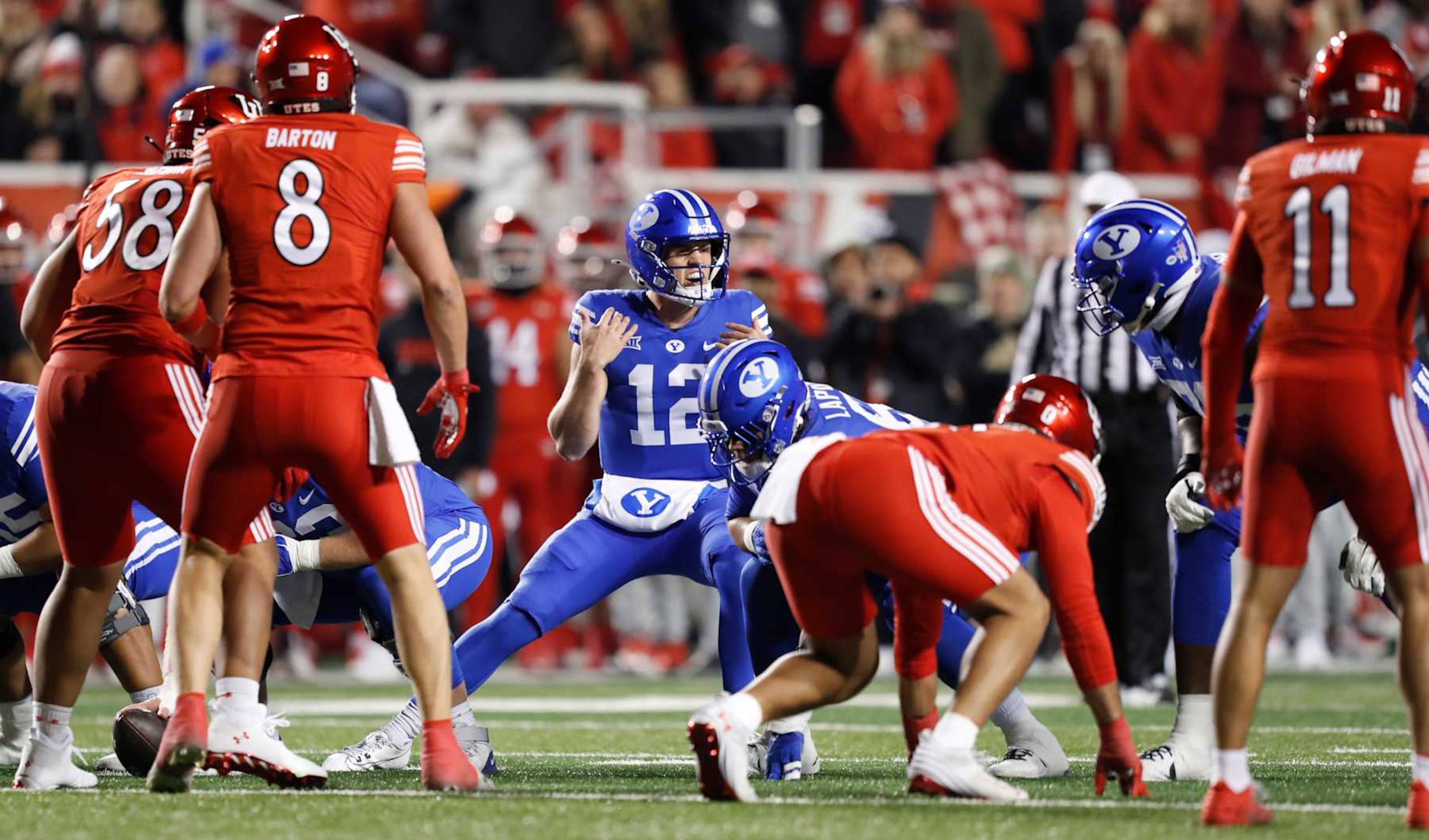 SALT LAKE CITY, UT - NOVEMBER 9:  Jake Retzlaff #12 of the Brigham Young Cougars changes the play at the line during the first half of their game agianst the Utah Utes at Rice-Eccles Stadium on November 9, 2024 in Salt Lake City, Utah.(Photo by Chris Gardner/Getty Images)