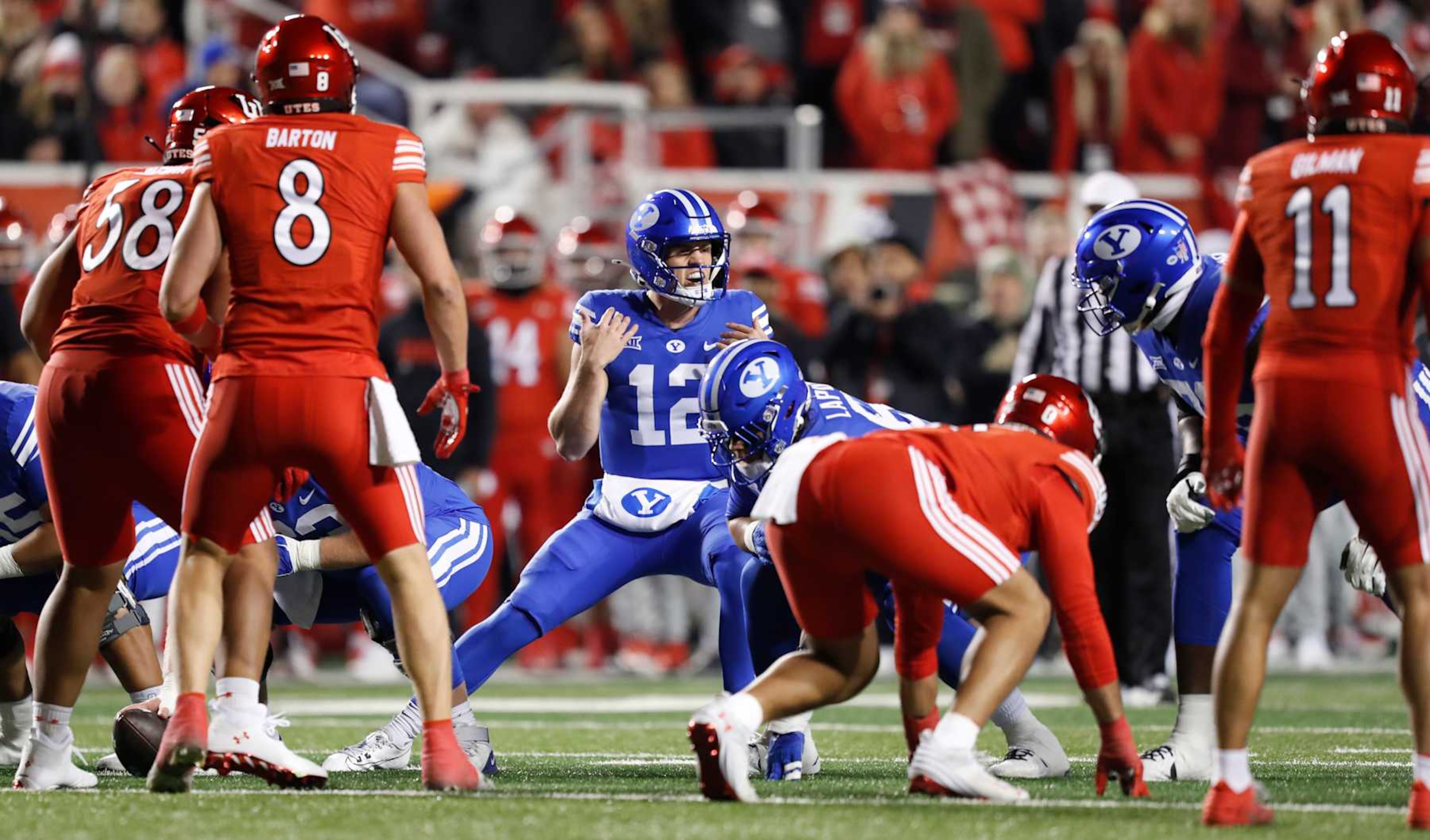 SALT LAKE CITY, UT - NOVEMBER 9:  Jake Retzlaff #12 of the Brigham Young Cougars changes the play at the line during the first half of their game agianst the Utah Utes at Rice-Eccles Stadium on November 9, 2024 in Salt Lake City, Utah.(Photo by Chris Gardner/Getty Images)