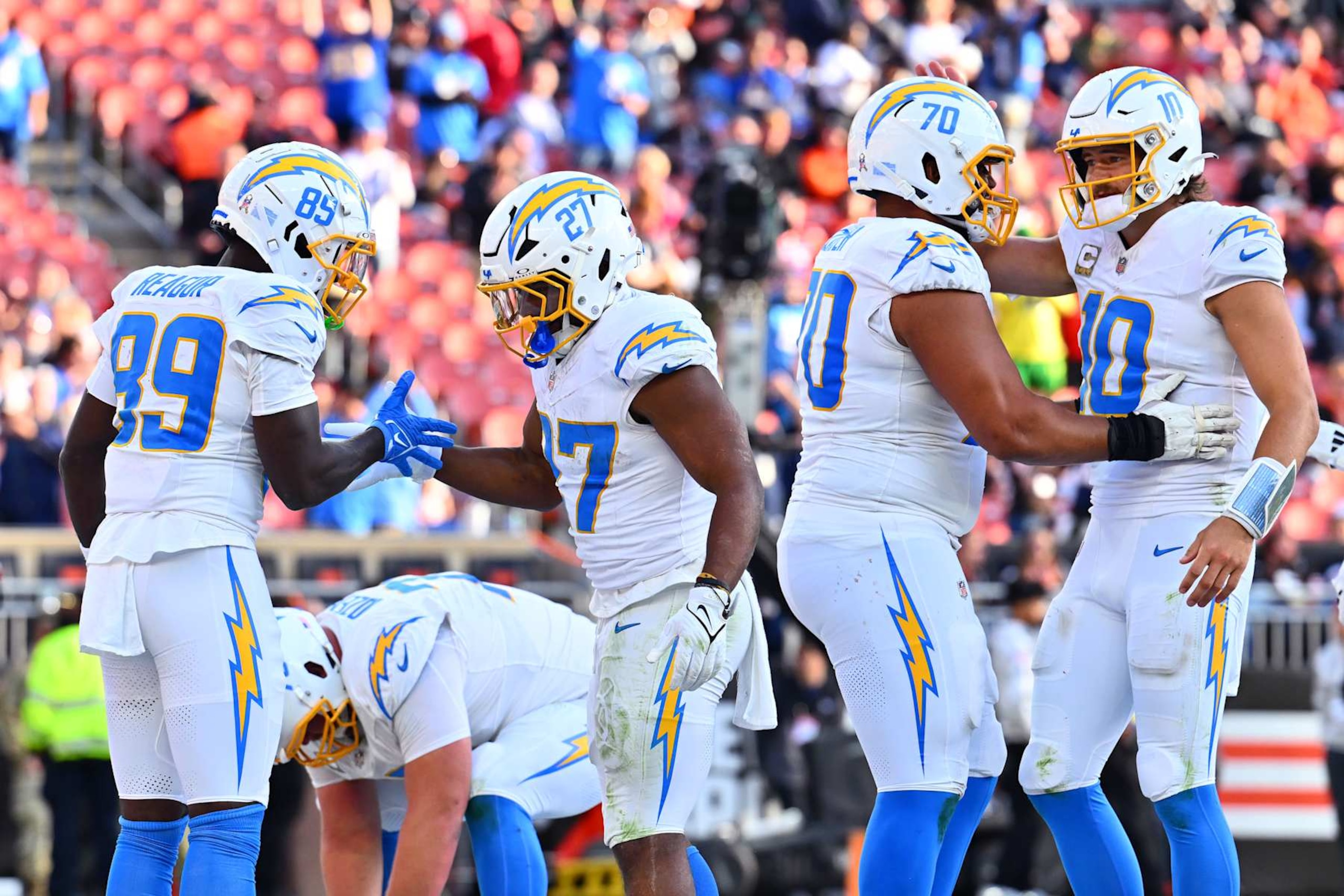 CLEVELAND, OHIO - NOVEMBER 03: Jalen Reagor #89, J.K. Dobbins #27, Rashawn Slater #70, and Justin Herbert #10 of the Los Angeles Chargers celebrate after Dobbins' rushing touchdown in the fourth quarter of a game against the Cleveland Browns at Huntington Bank Field on November 03, 2024 in Cleveland, Ohio. (Photo by Jason Miller/Getty Images)