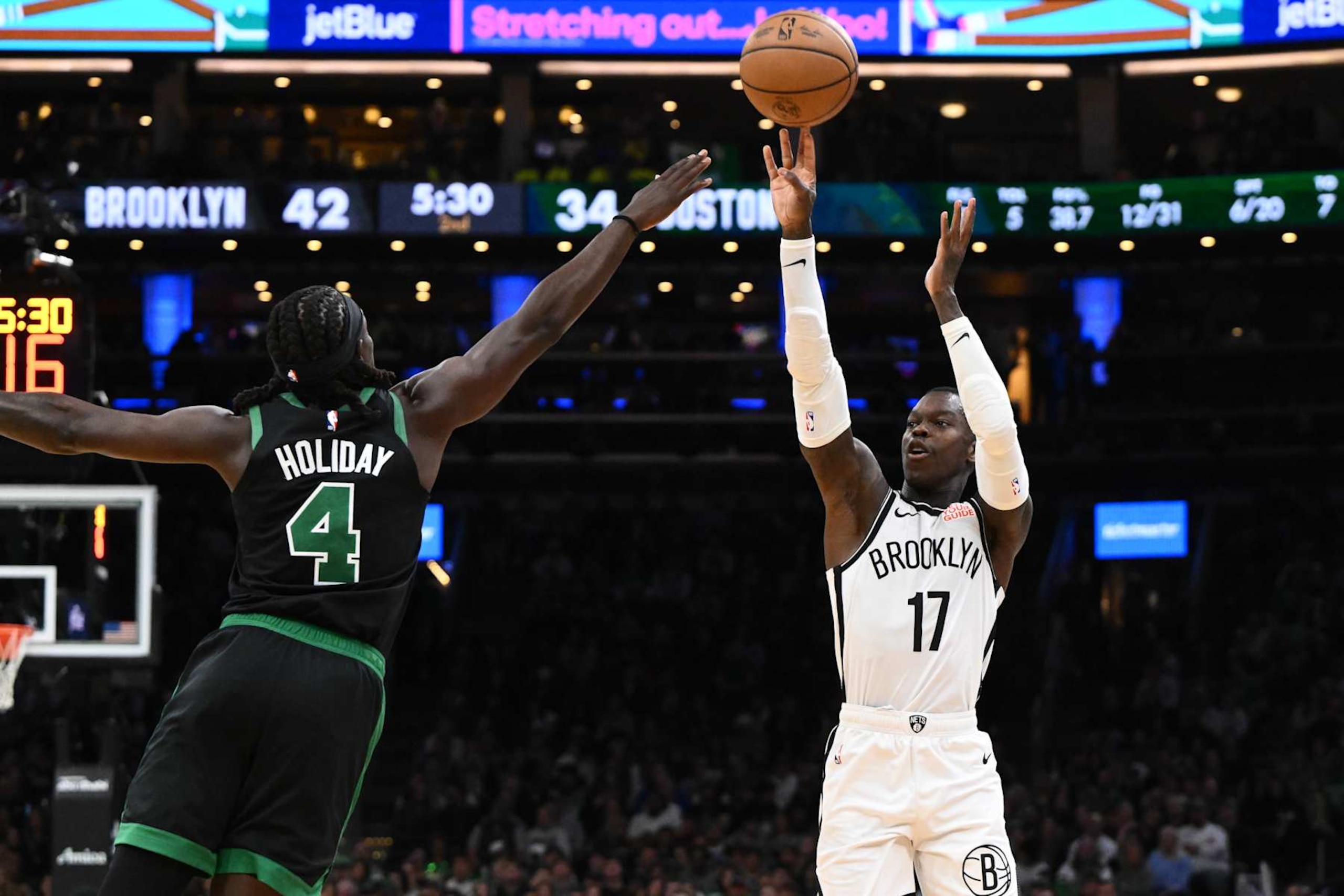 BOSTON, MASSACHUSETTS - NOVEMBER 08: Dennis Schroder #17 of the Brooklyn Nets attempts a basket against Jrue Holiday #4 of the Boston Celtics during the second quarter at the TD Garden on November 08, 2024 in Boston, Massachusetts. NOTE TO USER: User expressly acknowledges and agrees that, by downloading and or using this photograph, User is consenting to the terms and conditions of the Getty Images License Agreement. (Photo by Brian Fluharty/Getty Images)