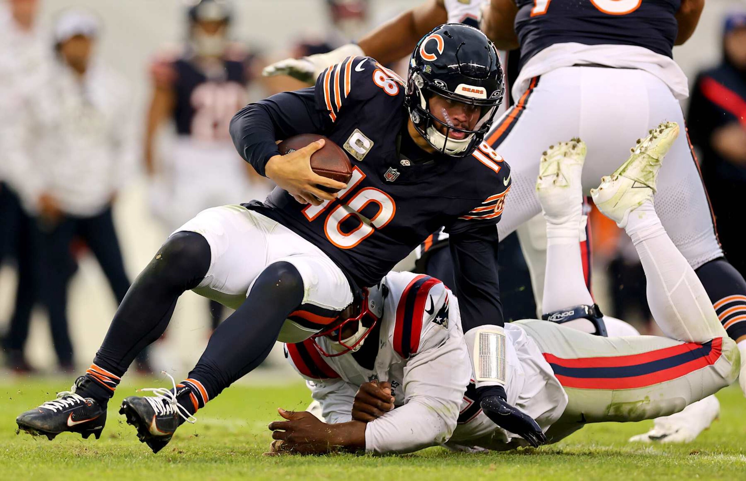 CHICAGO, ILLINOIS - NOVEMBER 10: Caleb Williams #18 of the Chicago Bears is sacked by Keion White #99 of the New England Patriots during the fourth quarter at Soldier Field on November 10, 2024 in Chicago, Illinois. (Photo by Michael Reaves/Getty Images) CHICAGO, ILLINOIS - NOVEMBER 10: Caleb Williams #18 of the Chicago Bears is sacked by Keion White #99 of the New England Patriots during the fourth quarter at Soldier Field on November 10, 2024 in Chicago, Illinois. (Photo by Michael Reaves/Getty Images)