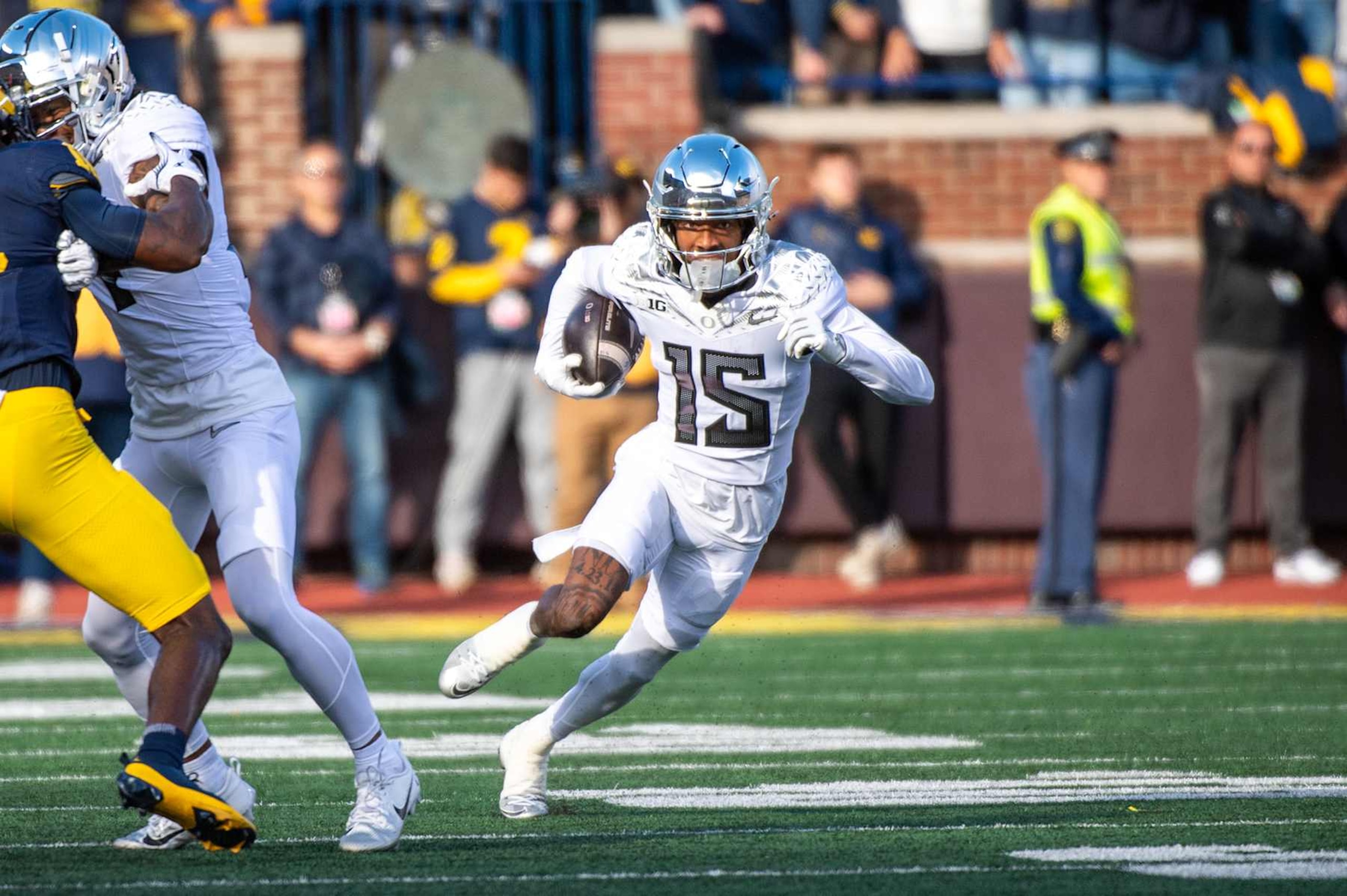 ANN ARBOR, MICHIGAN - NOVEMBER 02: Tez Johnson #15 of the Oregon Ducks runs with the ball during the first half of a college football game against the Michigan Wolverines at Michigan Stadium on November 02, 2024 in Ann Arbor, Michigan. The Oregon Ducks won the game 38-17. (Photo by Aaron J. Thornton/Getty Images) ANN ARBOR, MICHIGAN - NOVEMBER 02: Tez Johnson #15 of the Oregon Ducks runs with the ball during the first half of a college football game against the Michigan Wolverines at Michigan Stadium on November 02, 2024 in Ann Arbor, Michigan. The Oregon Ducks won the game 38-17. (Photo by Aaron J. Thornton/Getty Images)