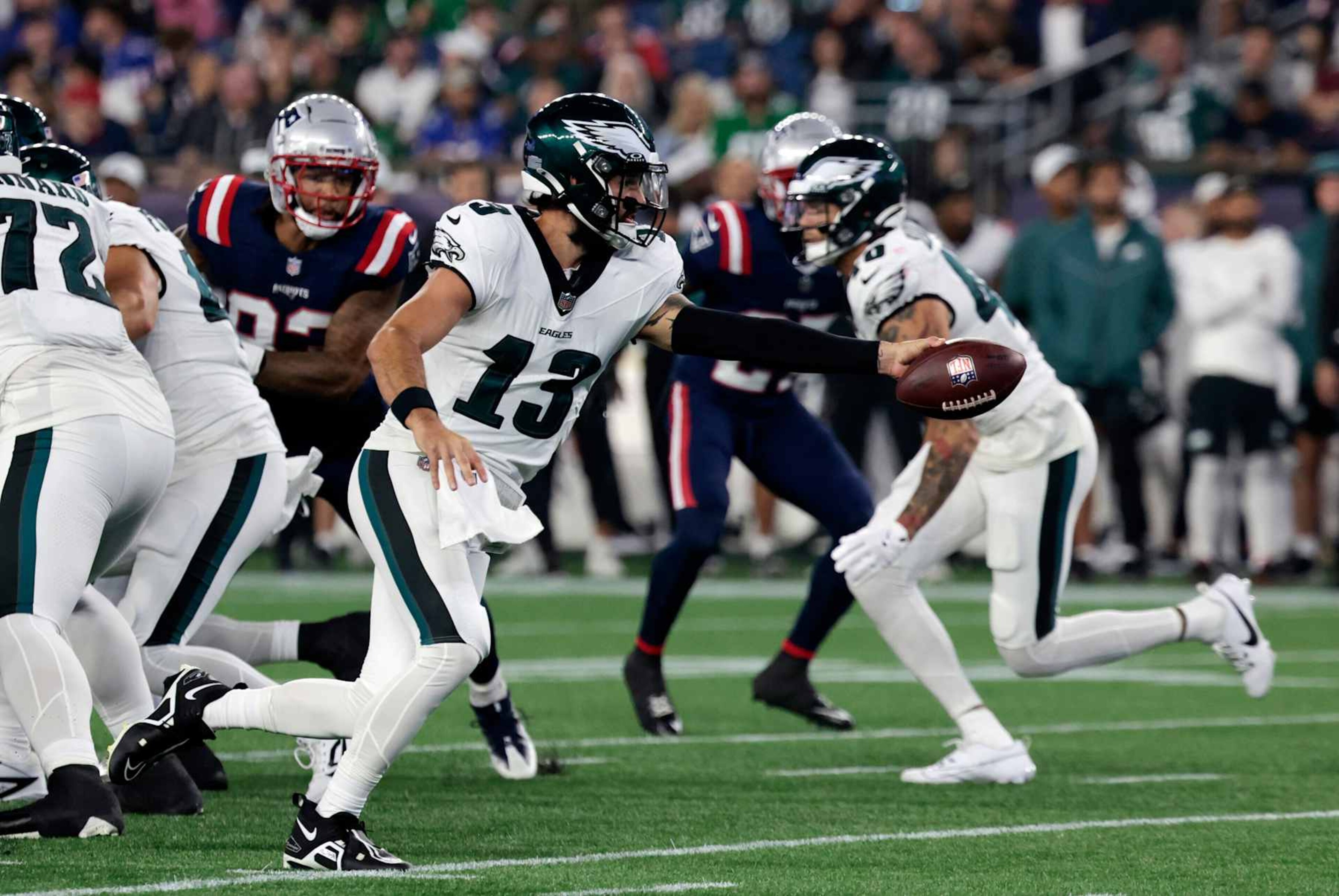 FOXBOROUGH, MA - AUGUST 15: Philadelphia Eagles quarterback Will Grier (13) reaches to hand the ball off during a preseason game between the New England Patriots and the Philadelphia Eagles on August 15, 2024, at Gillette Stadium in Foxborough, Massachusetts. (Photo by Fred Kfoury III/Icon Sportswire via Getty Images) FOXBOROUGH, MA - AUGUST 15: Philadelphia Eagles quarterback Will Grier (13) reaches to hand the ball off during a preseason game between the New England Patriots and the Philadelphia Eagles on August 15, 2024, at Gillette Stadium in Foxborough, Massachusetts. (Photo by Fred Kfoury III/Icon Sportswire via Getty Images)