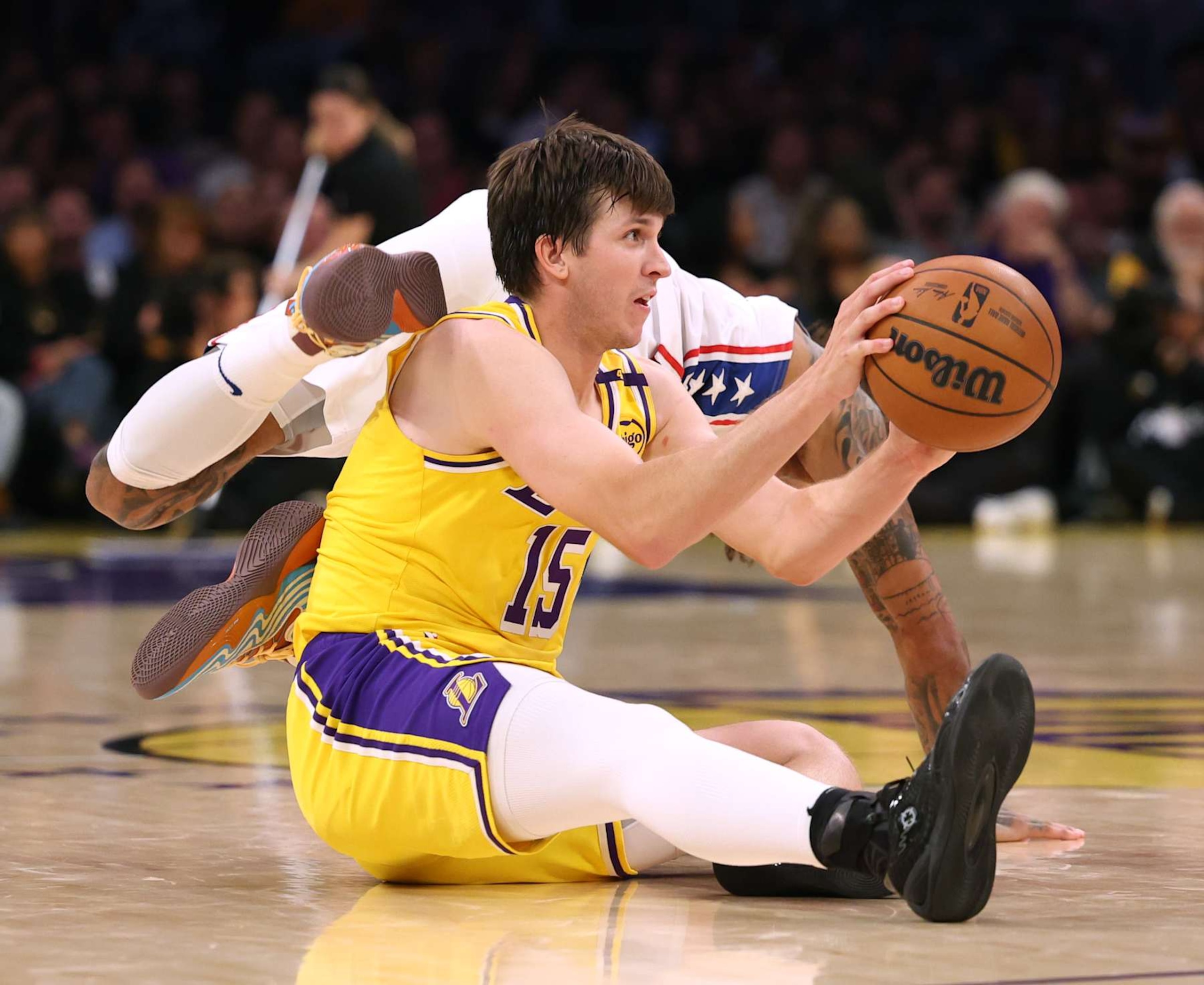 LOS ANGELES, CALIFORNIA - NOVEMBER 08: Austin Reaves #15 of the Los Angeles Lakers grabs a rebound in front of Kelly Oubre Jr. #9 of the Philadelphia 76ers during a 116-106 Lakers win at Crypto.com Arena on November 08, 2024 in Los Angeles, California. (Photo by Harry How/Getty Images) NOTE TO USER: User expressly acknowledges and agrees that, by downloading and/or using this Photograph, user is consenting to the terms and conditions of the Getty Images License Agreement. (Photo by Harry How/Getty Images)